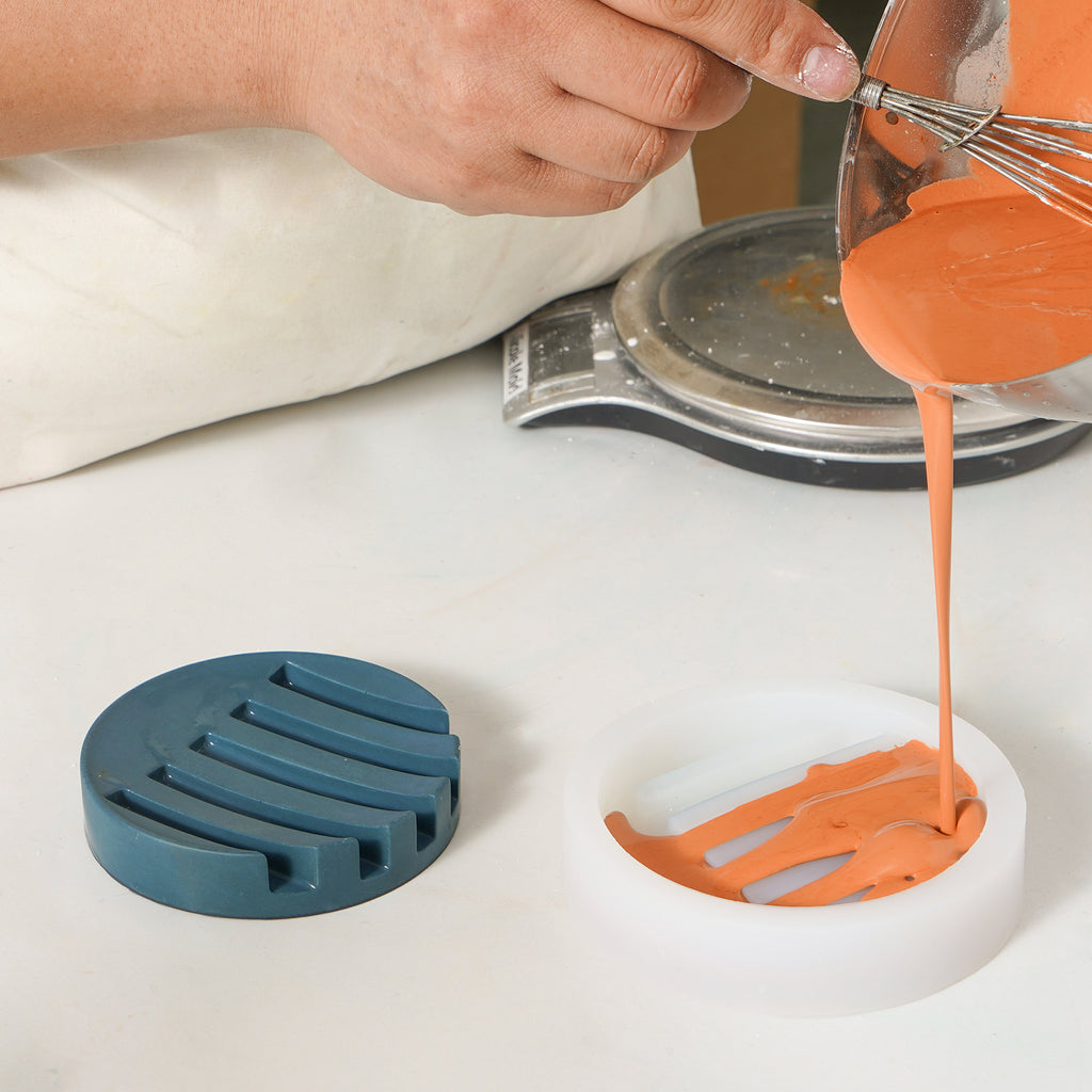 An orange soap dish popping out of boowannicole's silicone mold, showcasing impeccable craftsmanship.