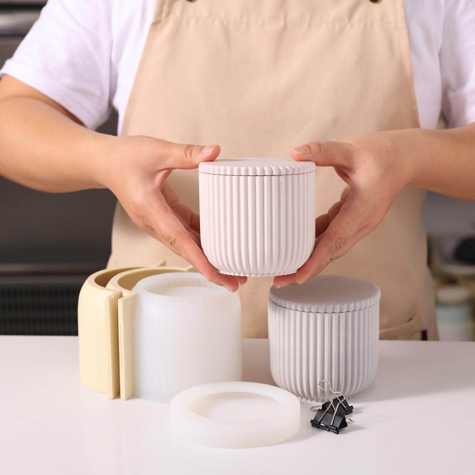 Handheld display of pink ridged flat-lid candle jars that combine aesthetics with functionality.