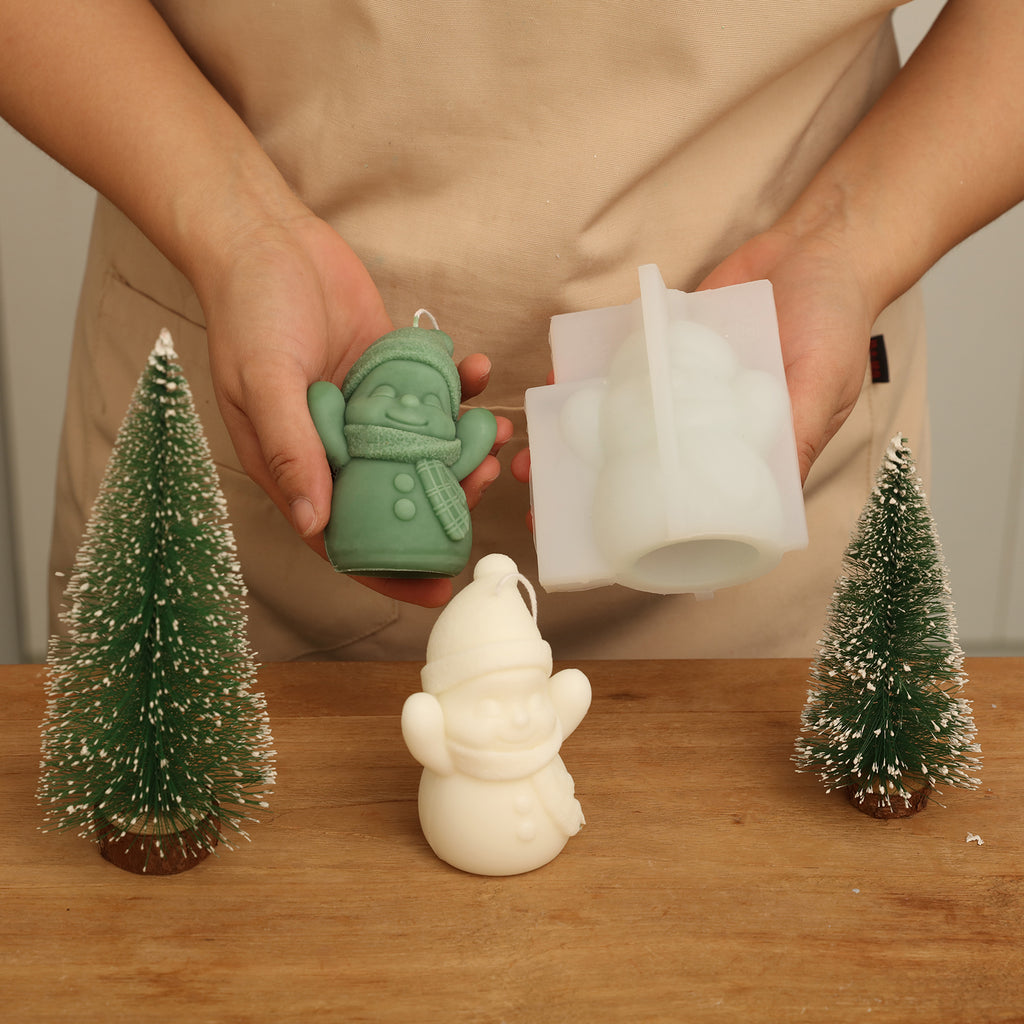 Handheld display of green Cheering Snowy Friends Candle and white silicone mould - Boowan Nicole