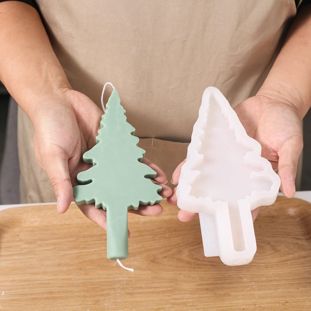Hand-held display of Christmas candles and silicone molds for detailed design.
