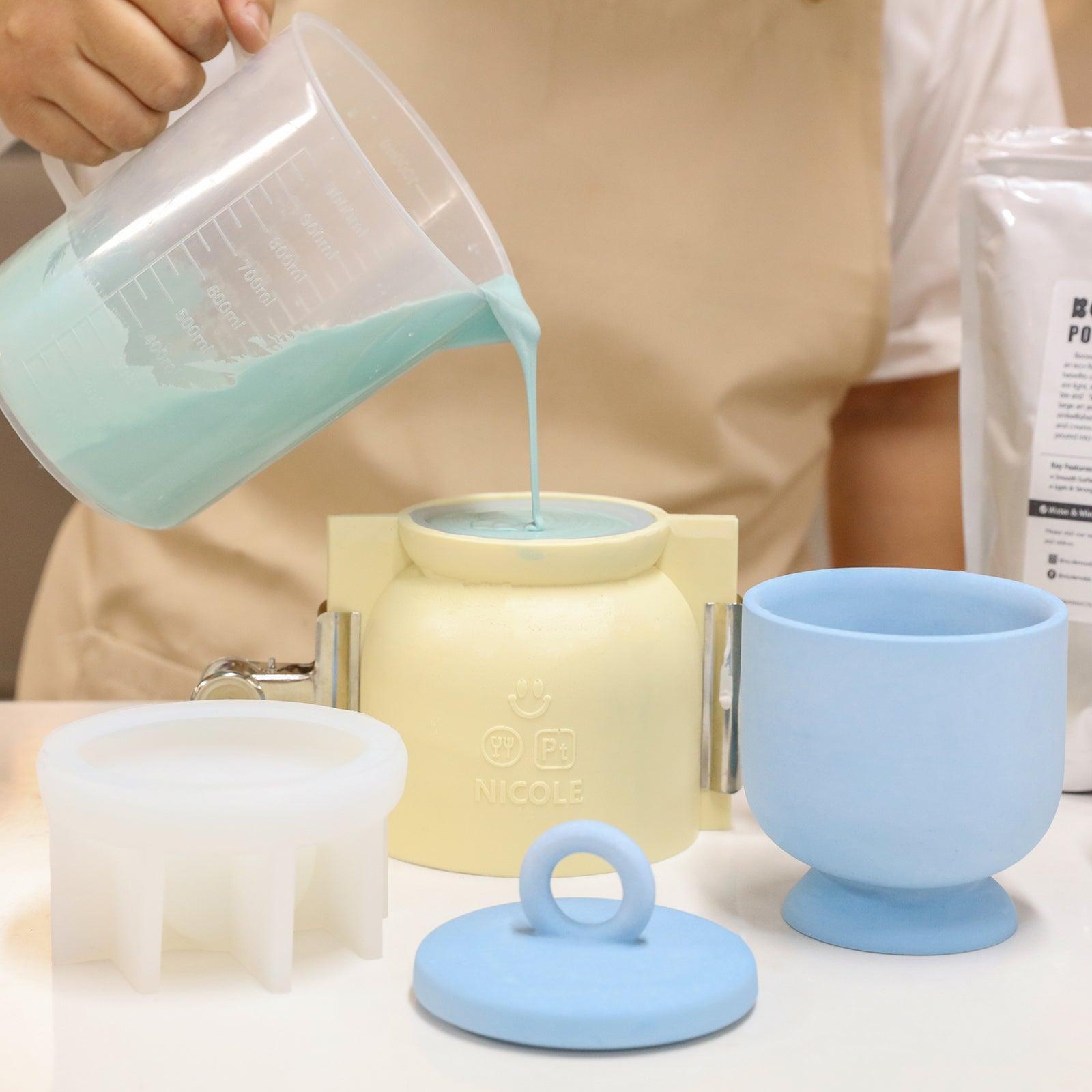 Pour blue boowannite material into silicone mold to make Chalice Tall Candle Jar with Ring Handle Lid-Boowan Nicole