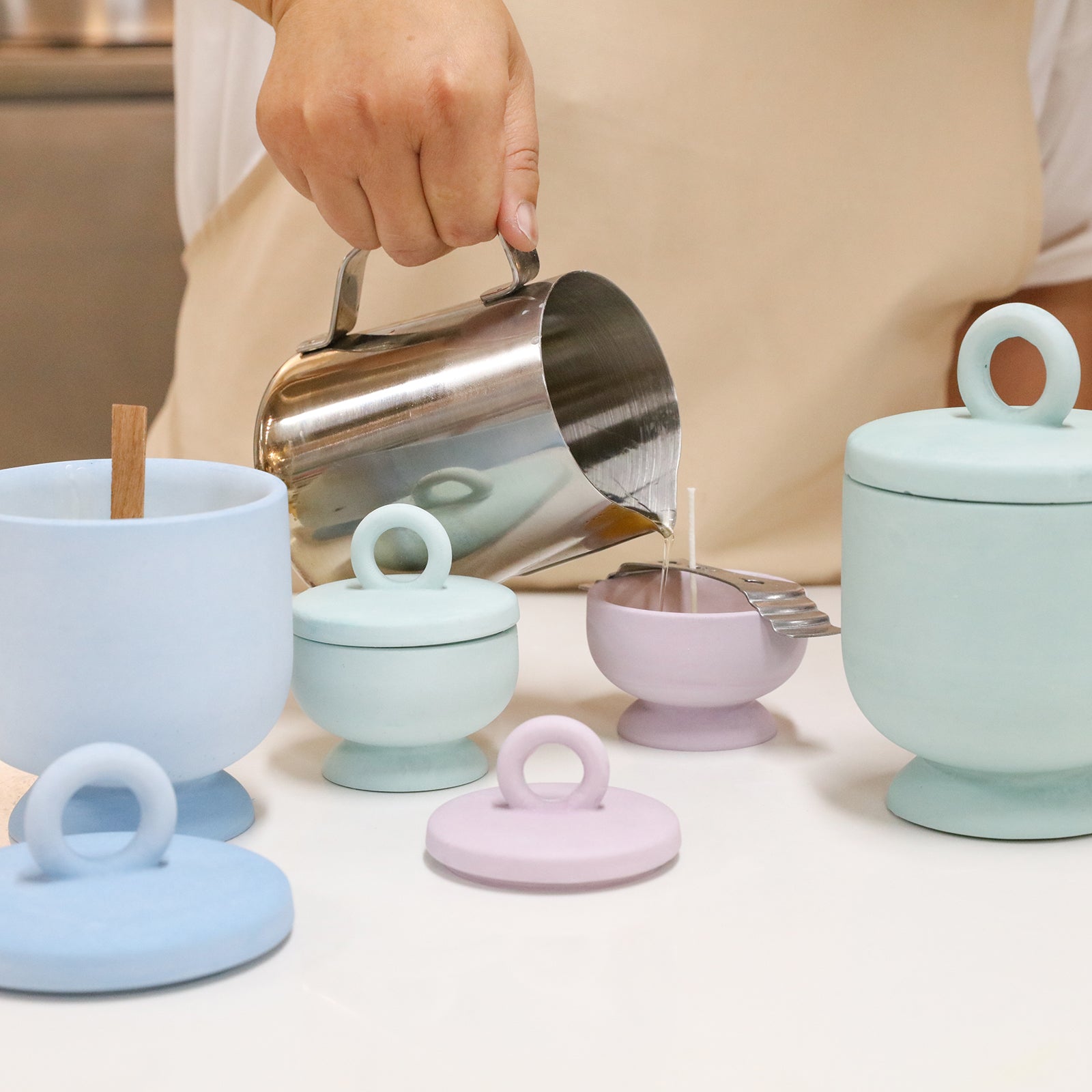 Pour the wax liquid into the small purple Chalice Candle Jar with Ring Handle Lid-Boowan Nicole