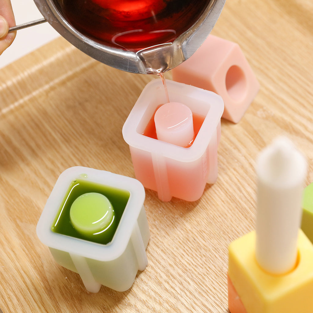 Pour the wax liquid into the white silicone mold to make Cube shape Stackable Candle -Boowan Nicole