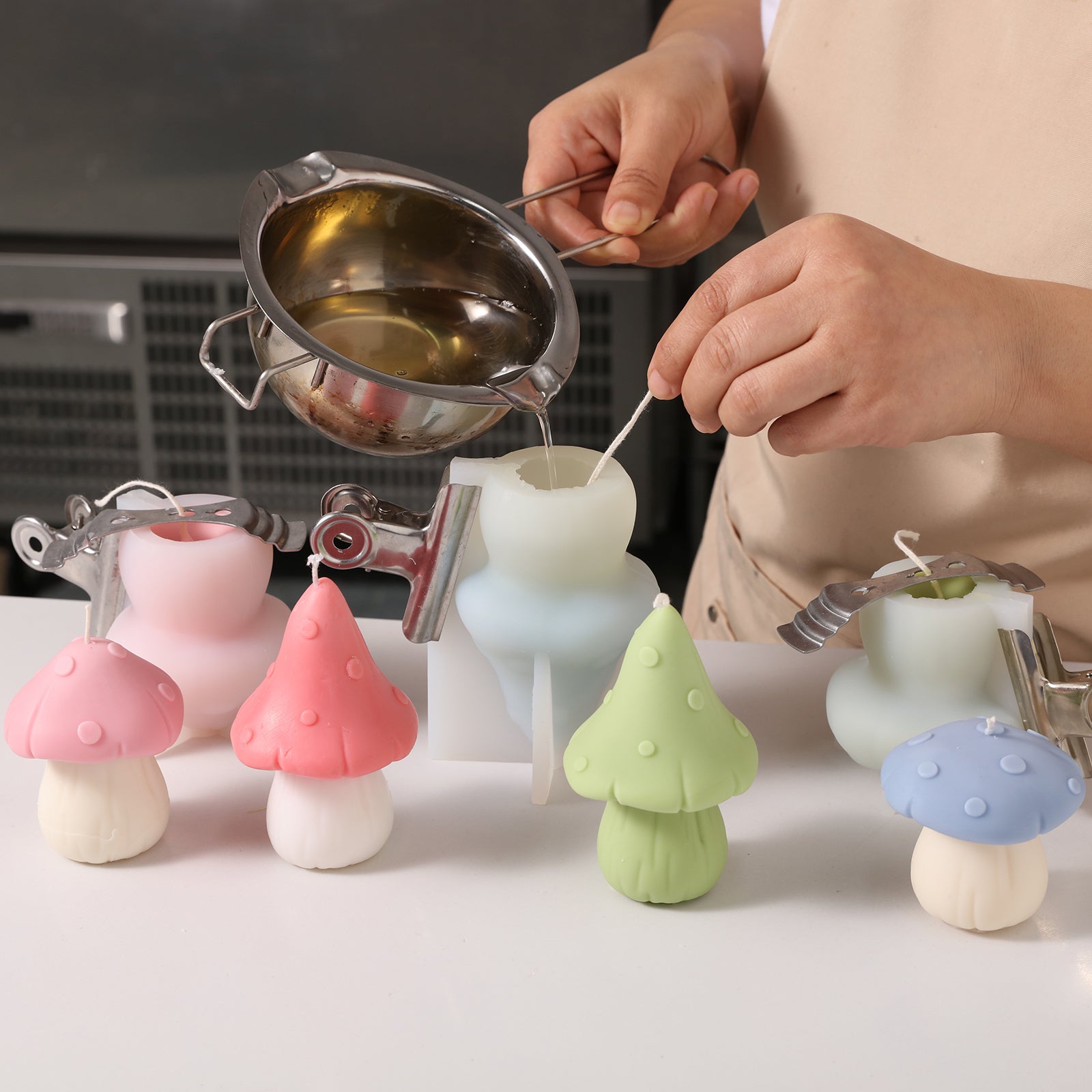 Pour liquid wax into silicone molds to create candles, designed by Boowan Nicole.