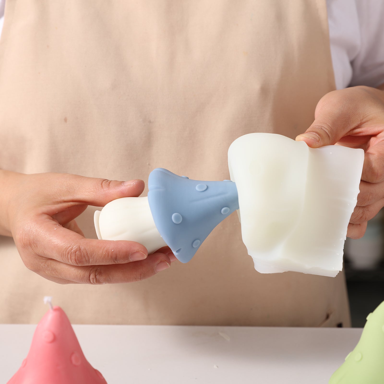 The blue canopy jungle mushroom shaped candle emerges from the white silicone mold, designed by Boowan Nicole.