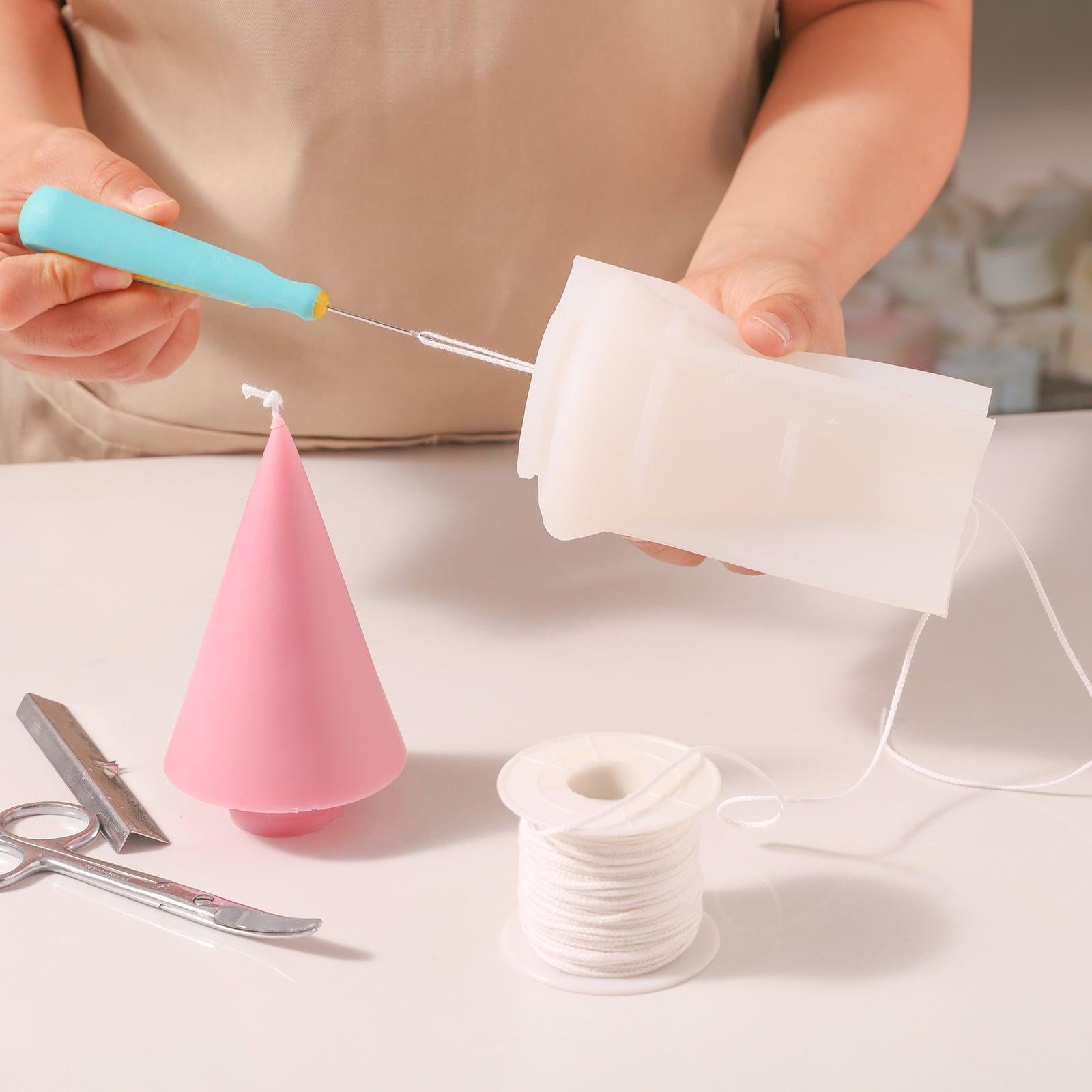 Use a threading tool to thread candle wicks from silicone molds - Boowan Nicole