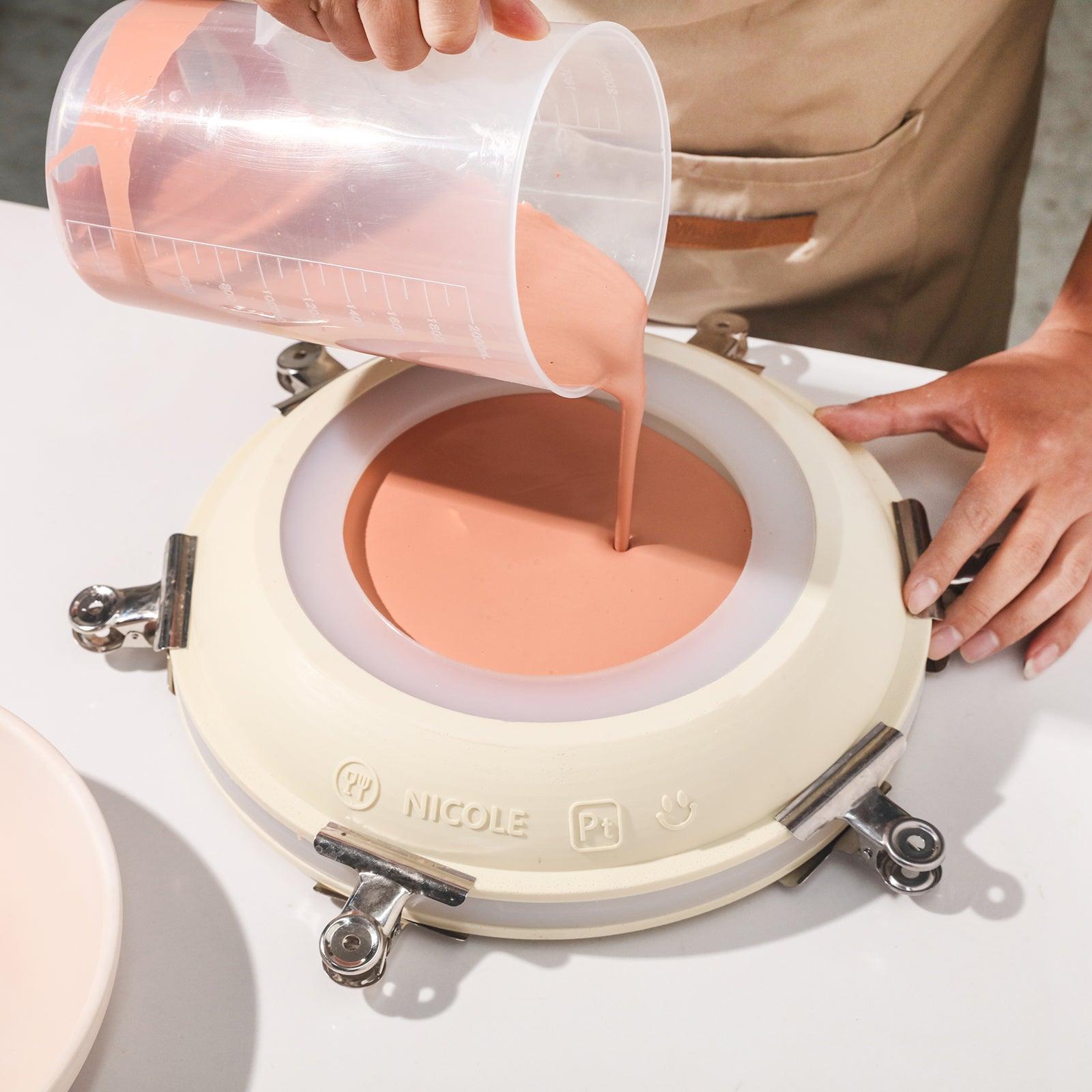Demonstrates the use of silicone molds to make large round trays.