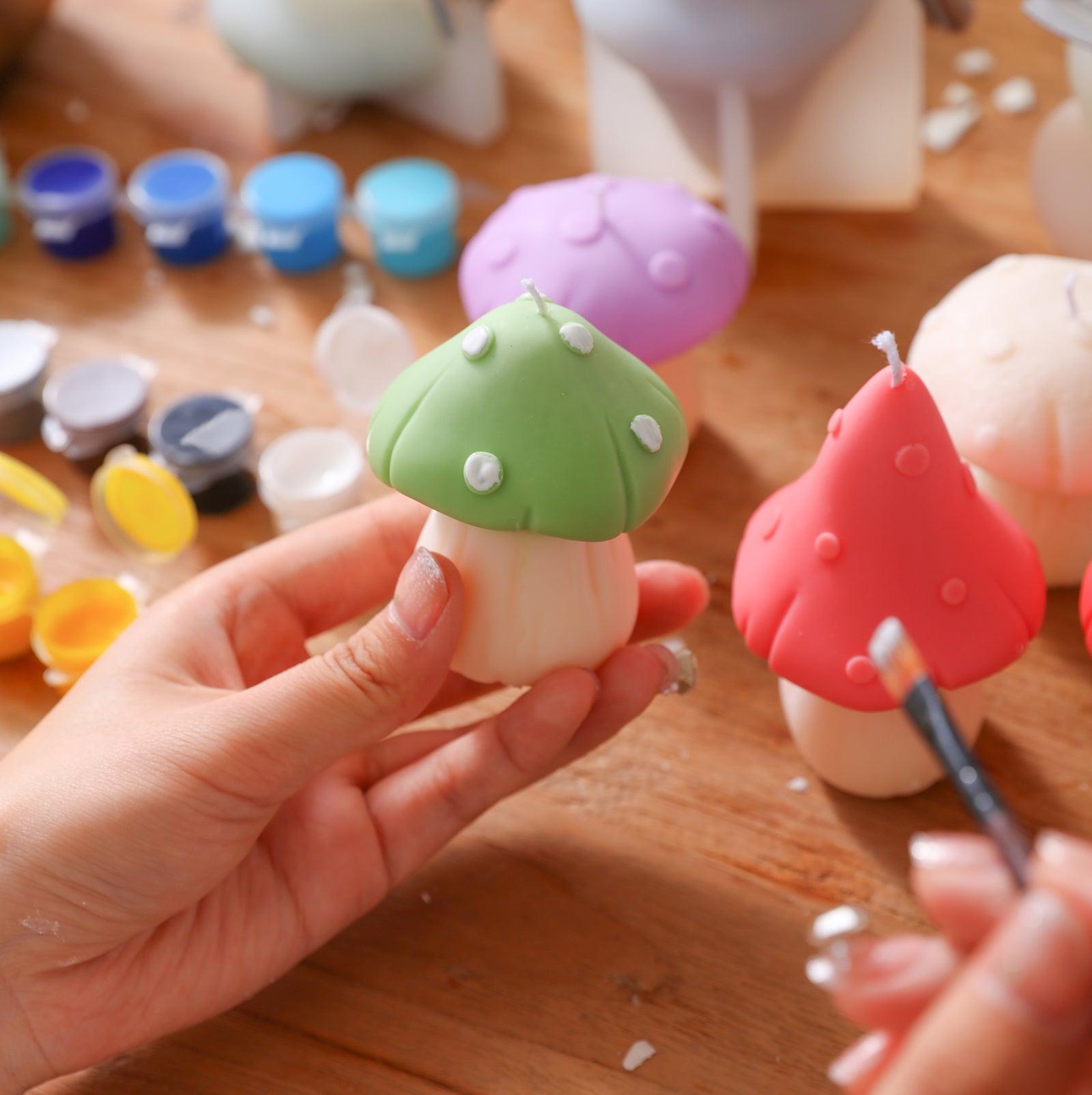 White flecks paint the green-canopied fungus mushroom-shaped candle, designed by Boowan Nicole.