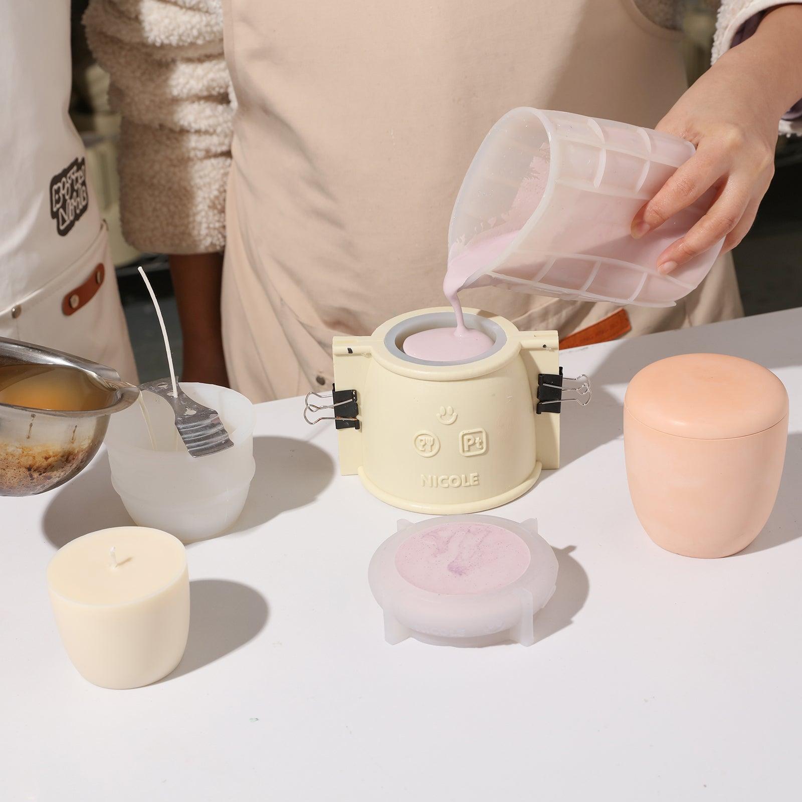 Use silicone molds to create a display of pebble-shaped candle jars.