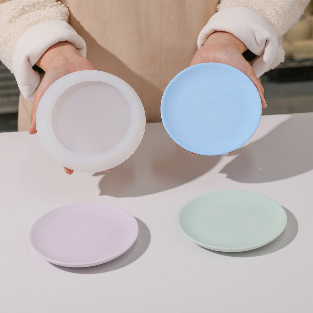 A showcase of precision craftsmanship - the silicone mold alongside the flawlessly demolded round trays, held with finesse.