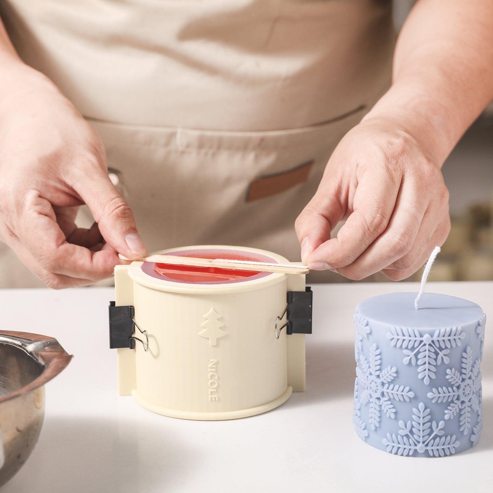 Create a snowflake embossed cylinder candle using a silicone mold designed by Boowan Nicole.