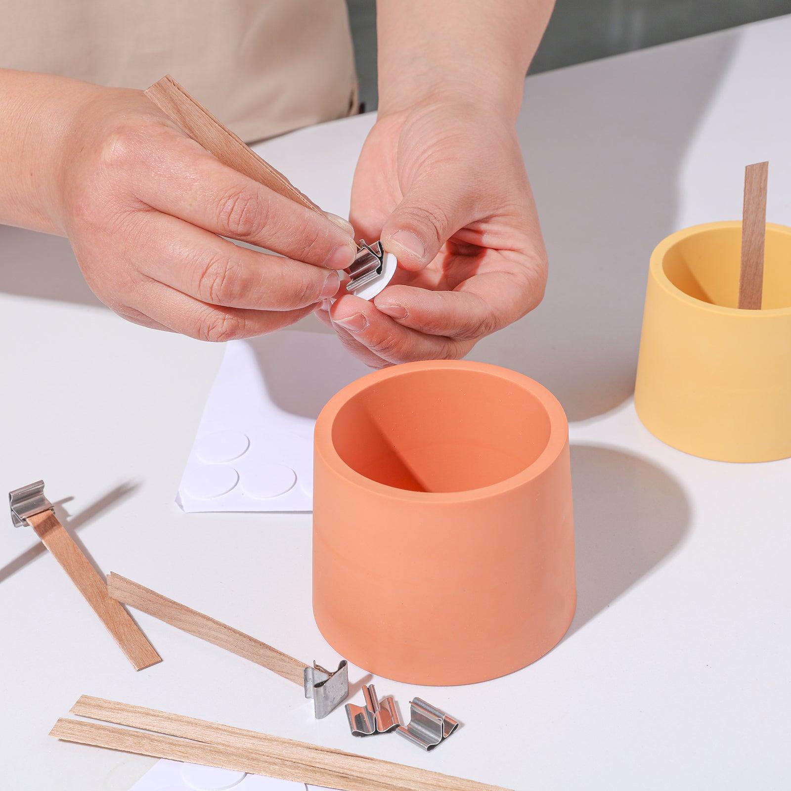 Crafting ambiance: Placing a wooden wick into a Boowannicole candle jar made with exquisite Boowannite material.