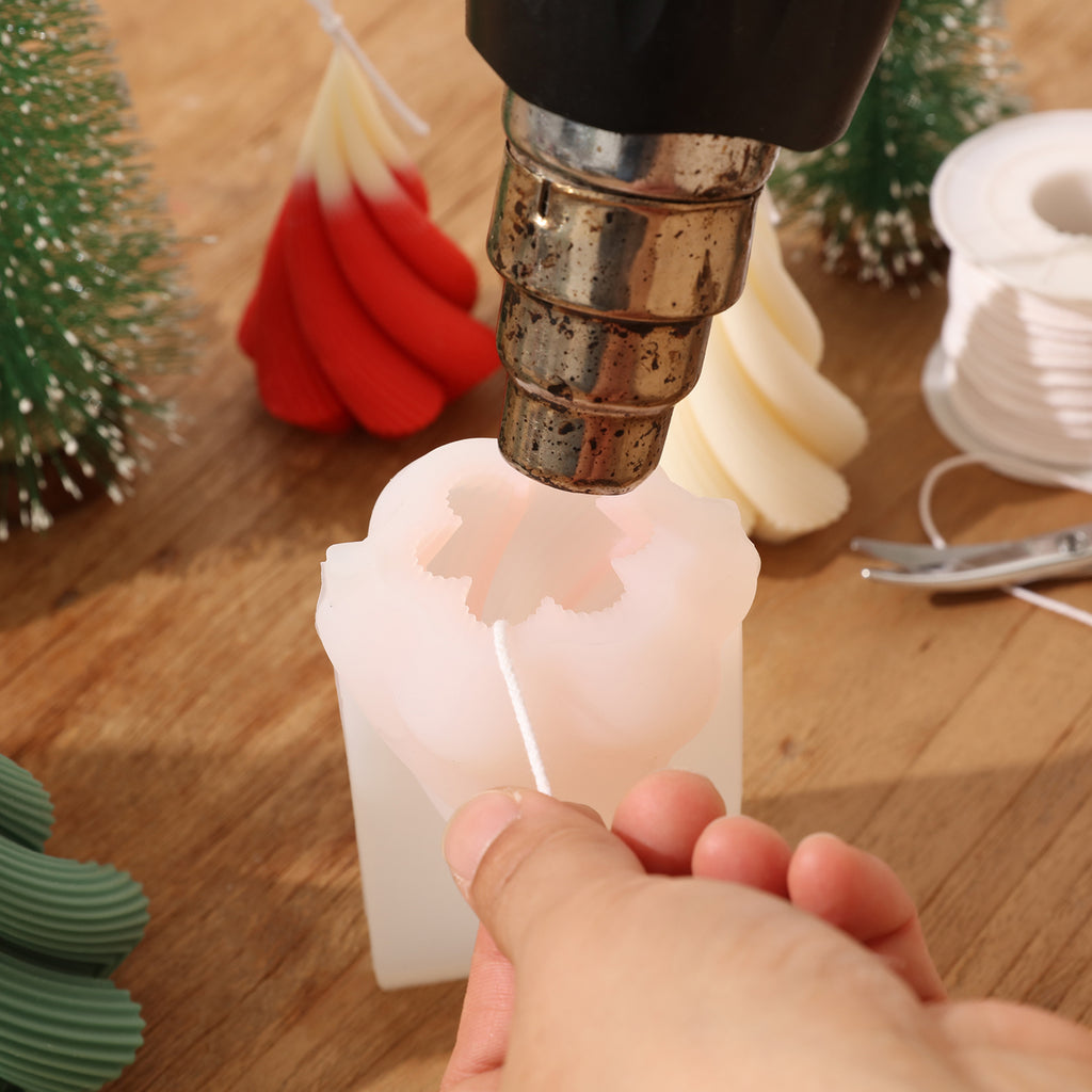 Use a heat gun to heat the silicone mold for making Spiral Christmas Tree Candle -Boowan Nicole