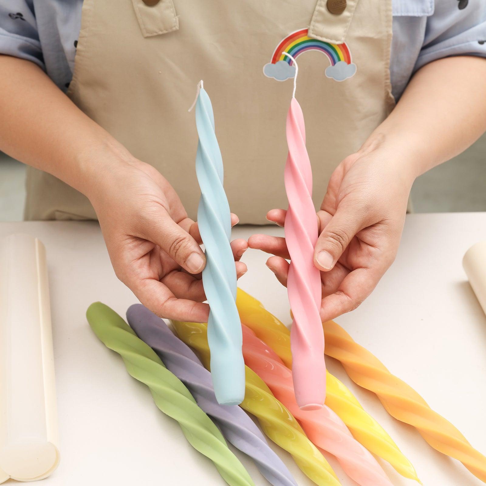 Spiral taper candles crafted with Boowannicole silicone molds, delicately held in hand. Boowannicole