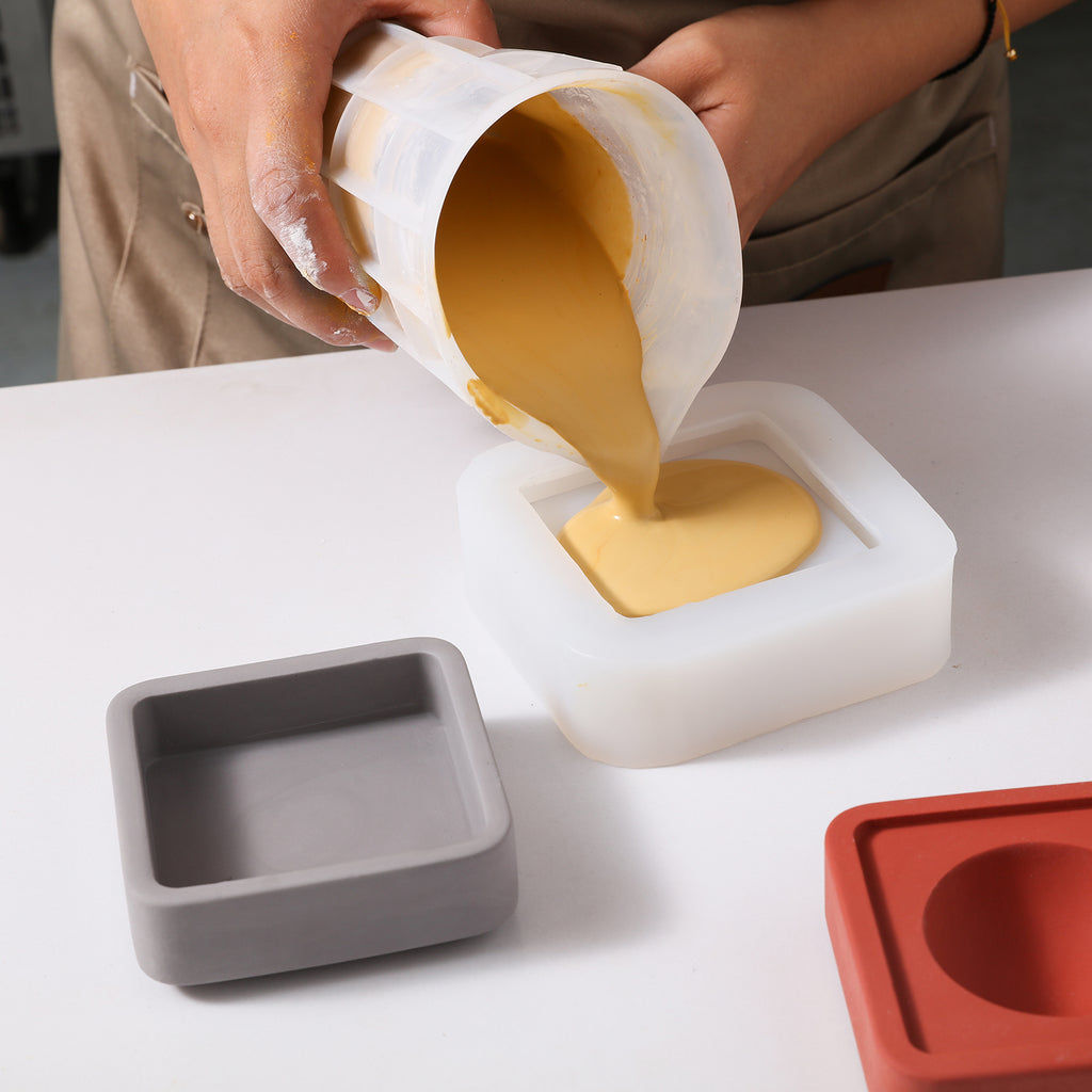 Pour the yellow boowannite material into the white silicone mold to make Square Multi-Functional Stationery Support-Boowan Nicole