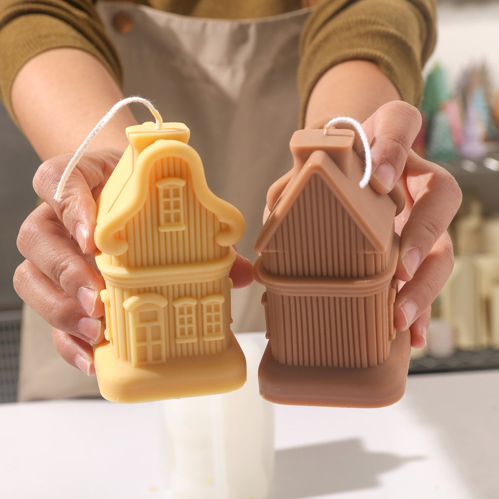 Hand-held display of yellow and brown house candles, designed by Boowan Nicole.