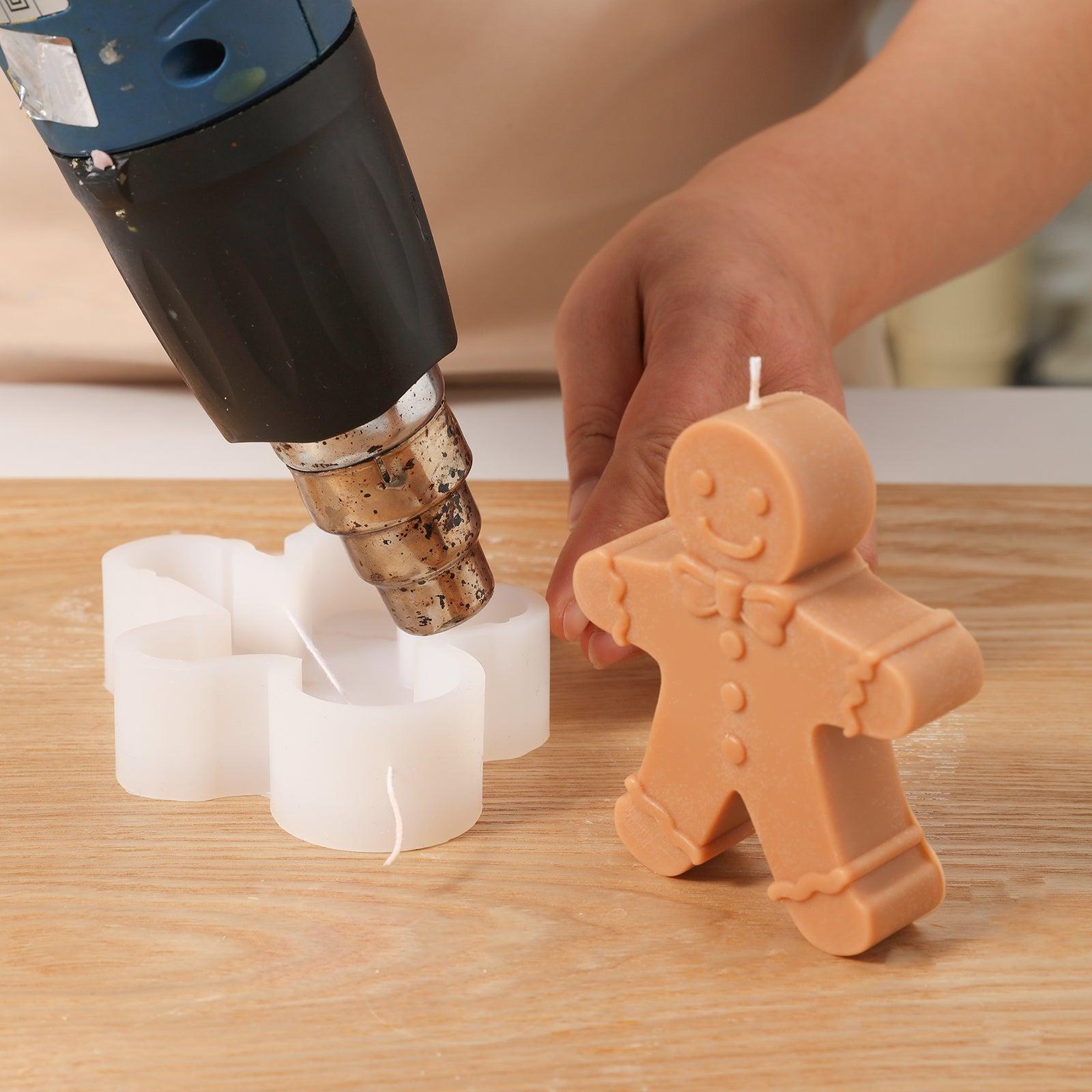Use a heat gun to heat a white silicone mold to make Gingerbread Papa Candle - Boowan Nicole