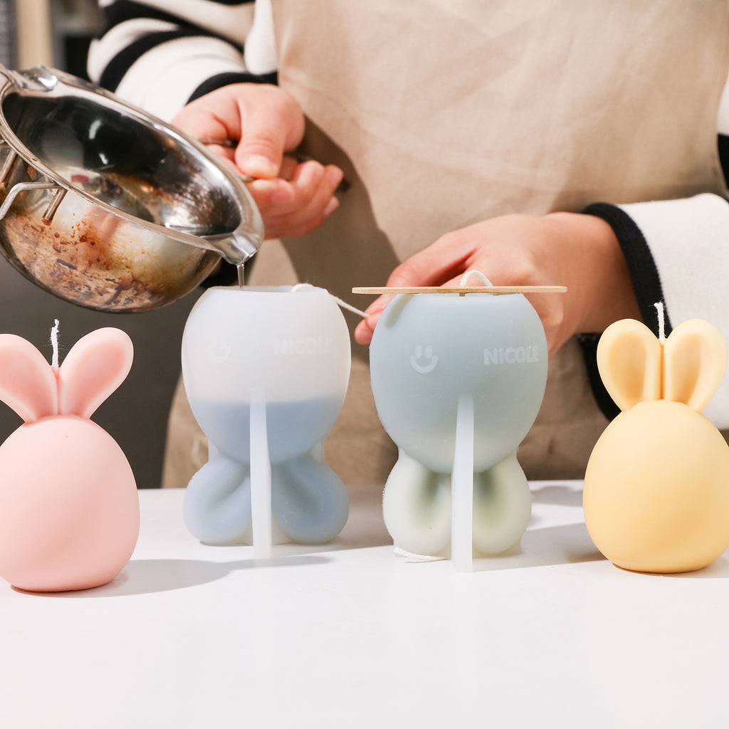 Crafting Easter Bunny Candles using a mold, showcasing handmade creativity.