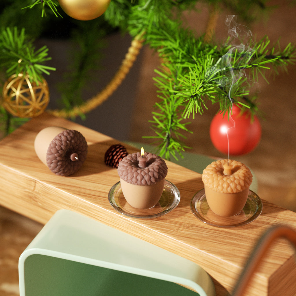 Three acorn-shaped candles are placed on a wooden surface, perfect for Christmas holiday decor-Boowan Nicole