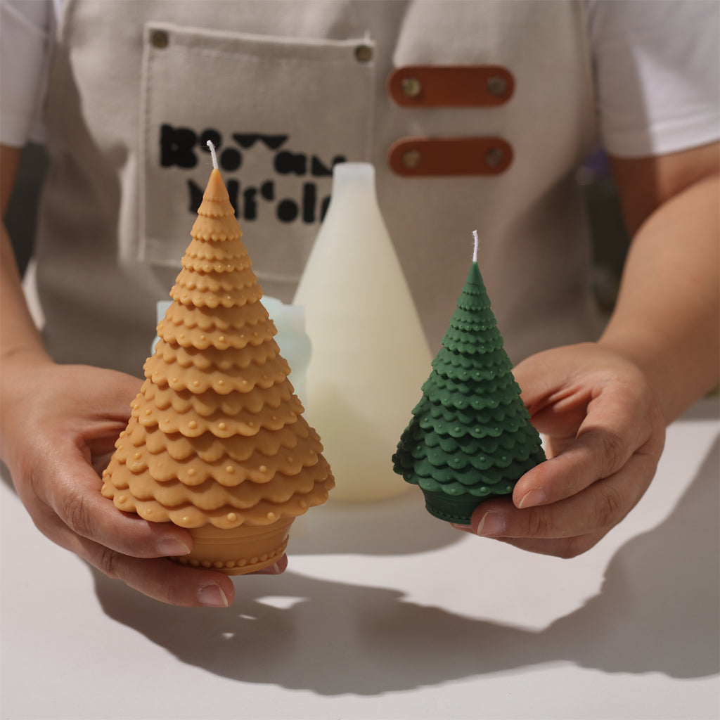 Display the unmolded small green Christmas tree candle and large brown Christmas tree candle-Boowan Nicole