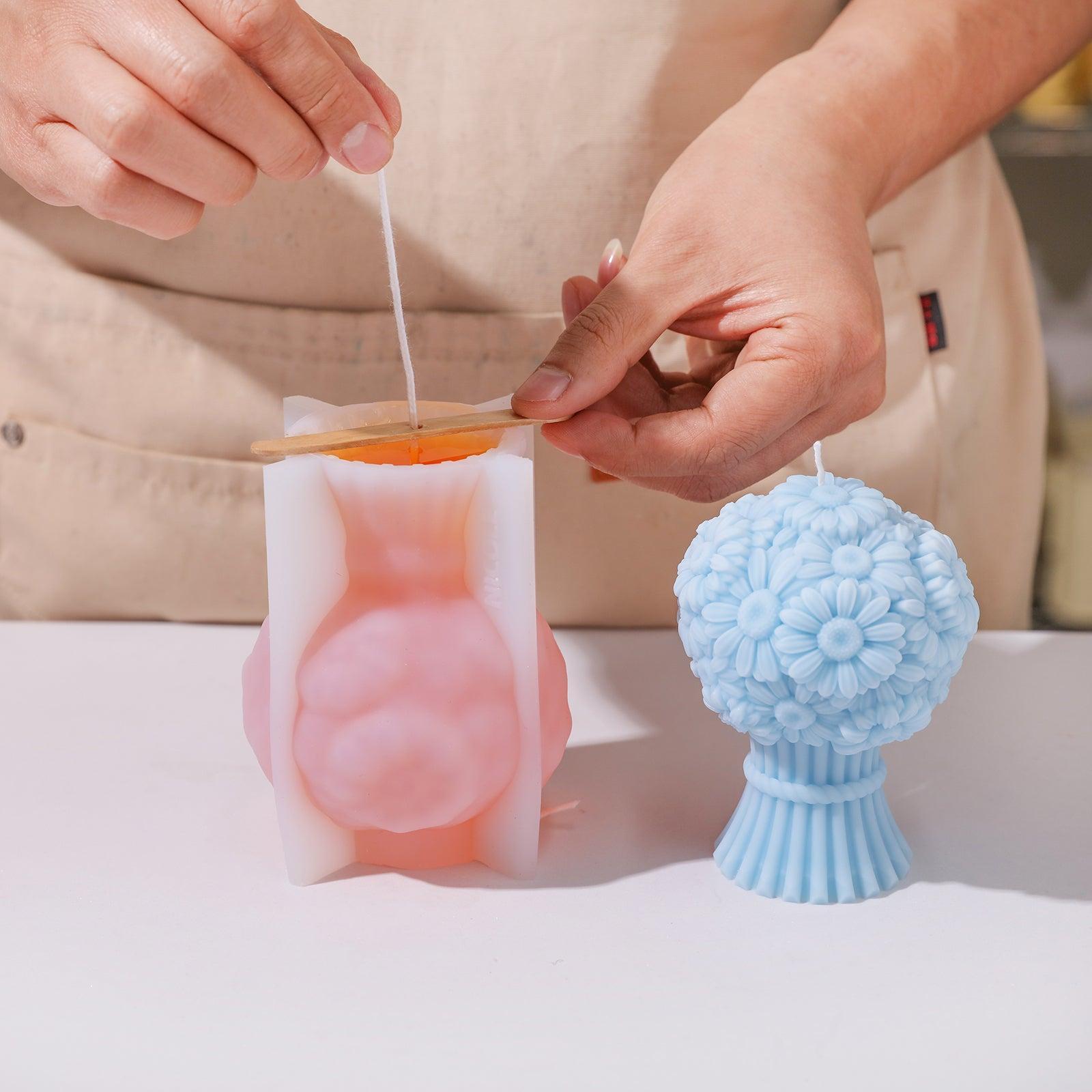 Pour yellow liquid wax into silicone mold to create Daisy Bouquet Flourishing Candle-Boowan Nicole