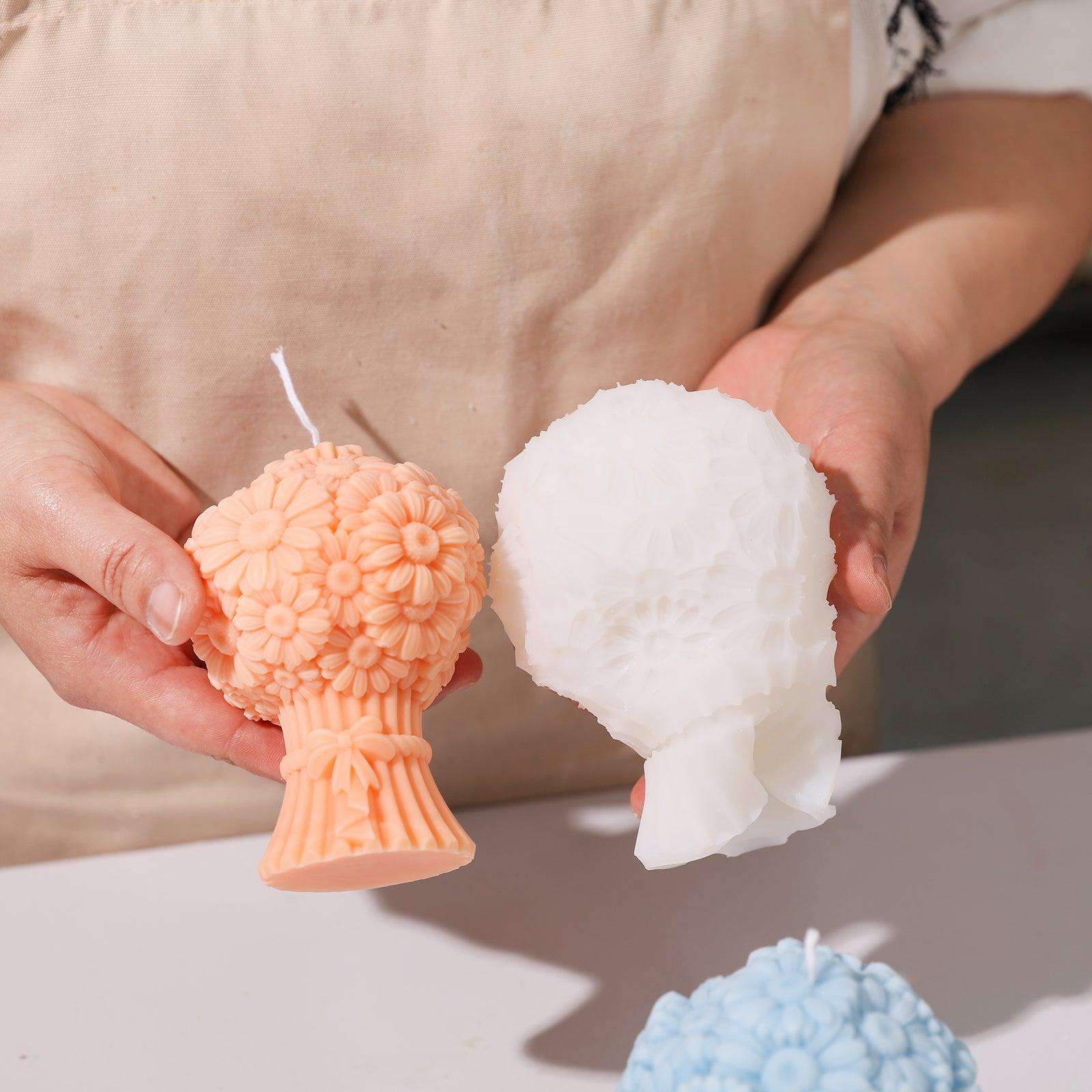 Hand-held display of yellow-pink Daisy Bouquet Flourishing Candle and white silicone mold-Boowan Nicole