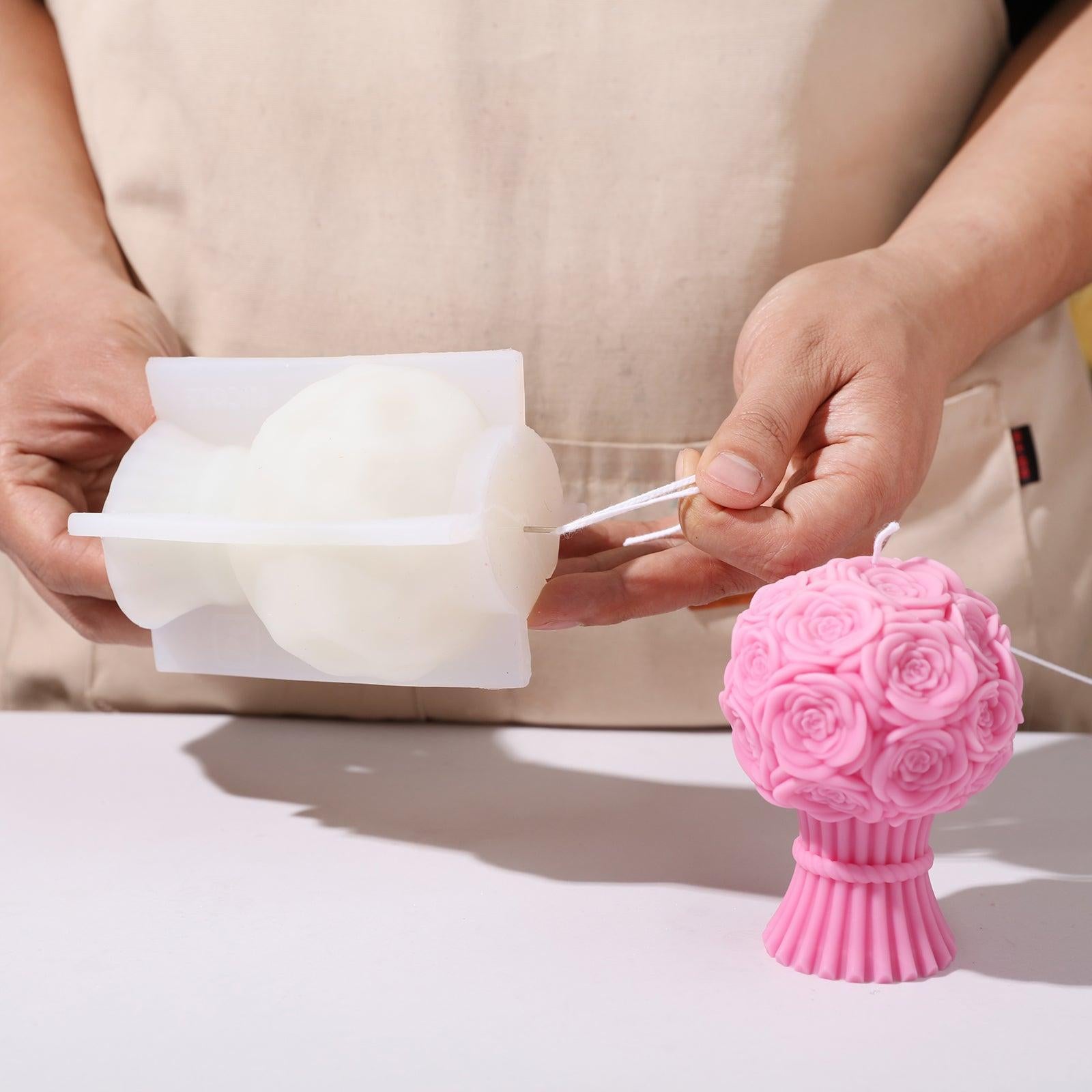 Using a tool to thread the candle wick through the silicone mold for the Rose Bouquet Flourishing Candle - Boowan Nicole