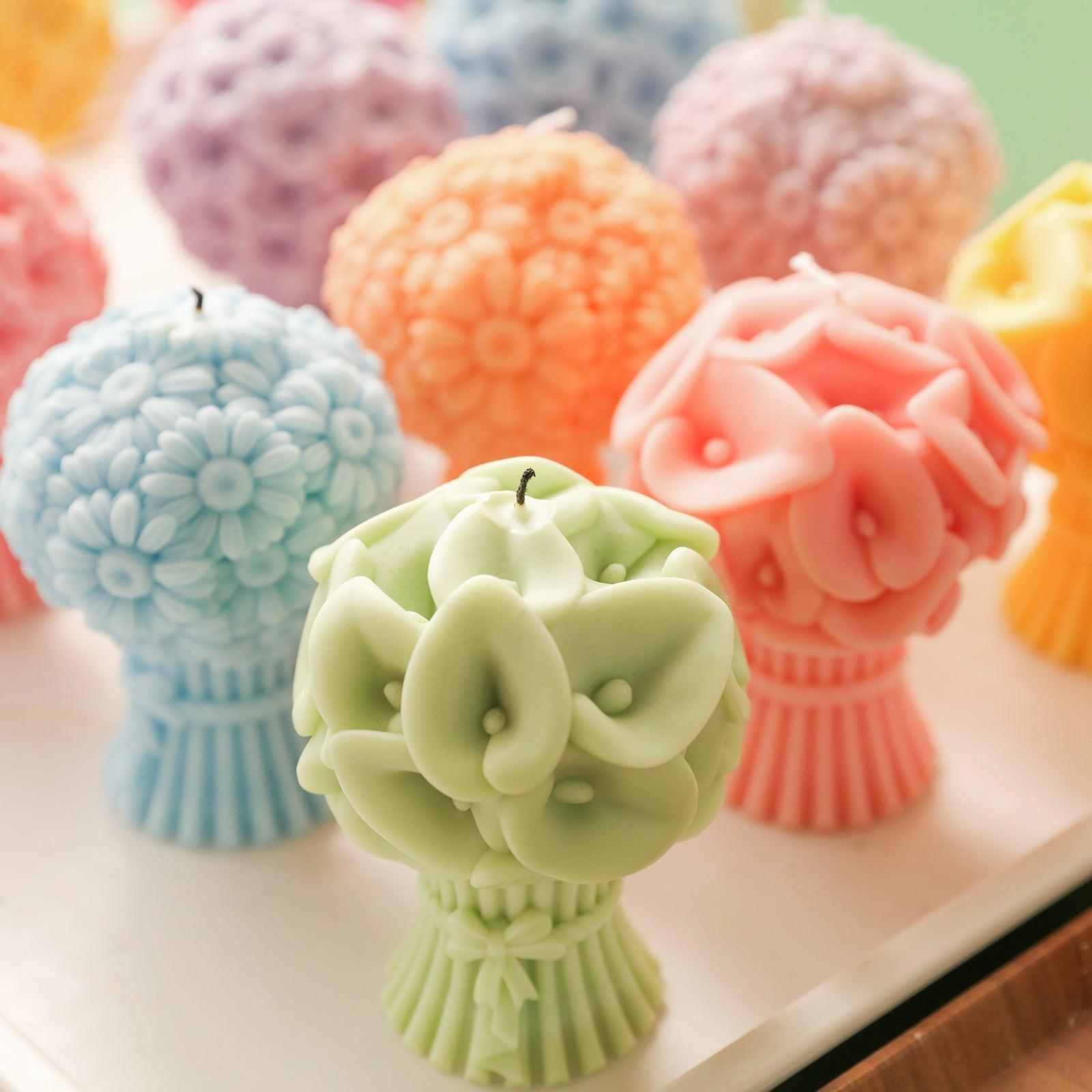 Behind the green Calla Lily Bouquet Flourishing Candle on the table are other bouquet-shaped candles -Boowan Nicole