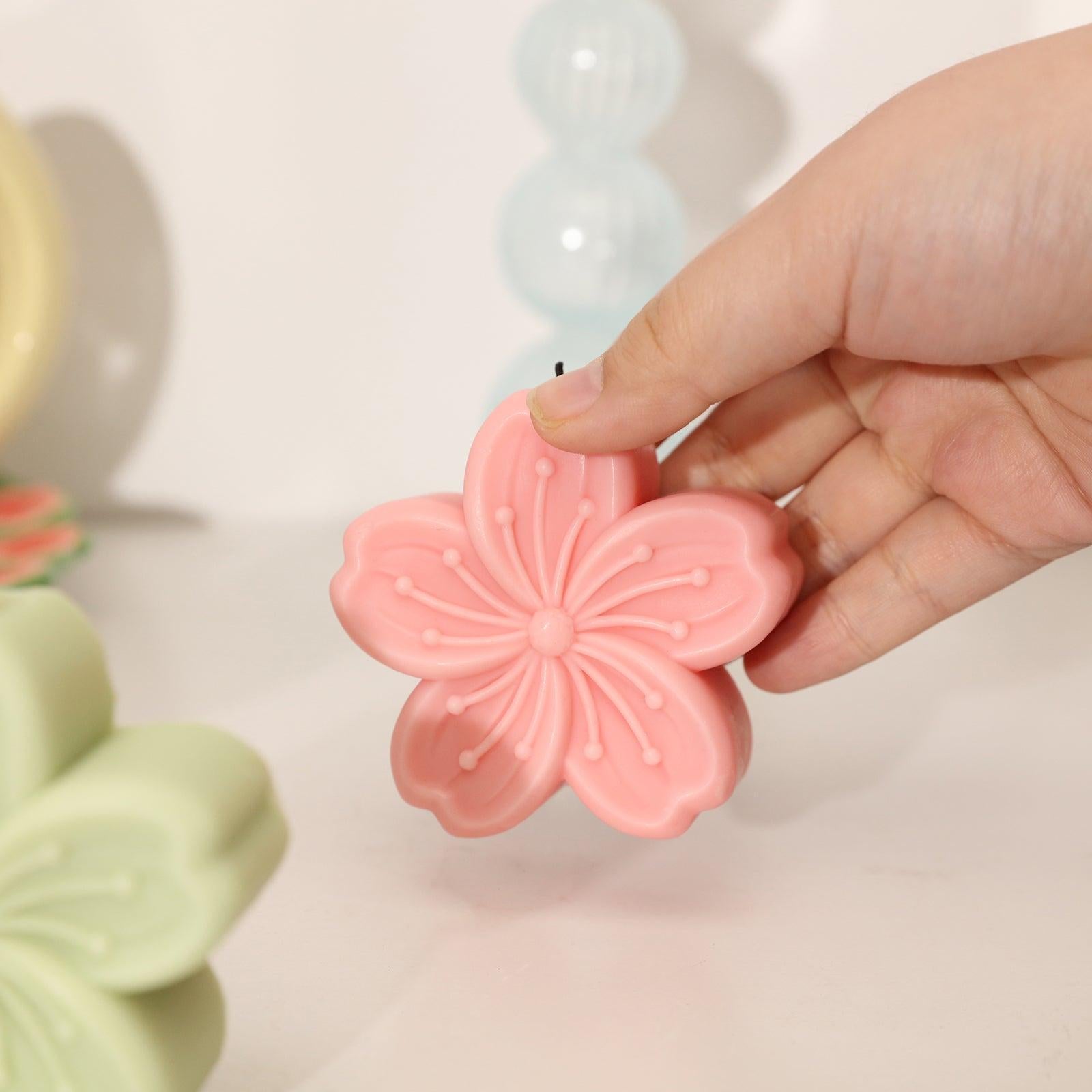 Holding a pink Sakura Candle-Boowan Nicole