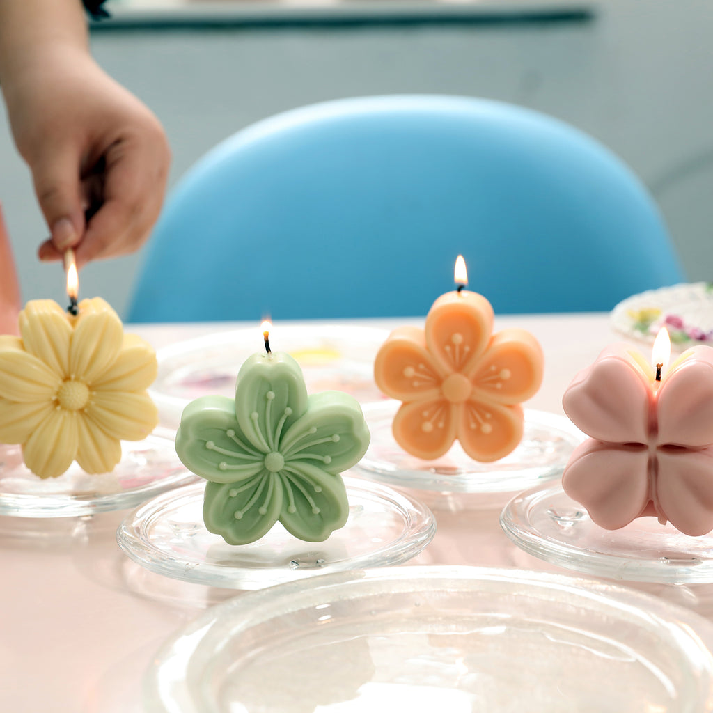 Pink, orange, green and yellow Sakura Candle in a crystal tray on the table - Boowan Nicole