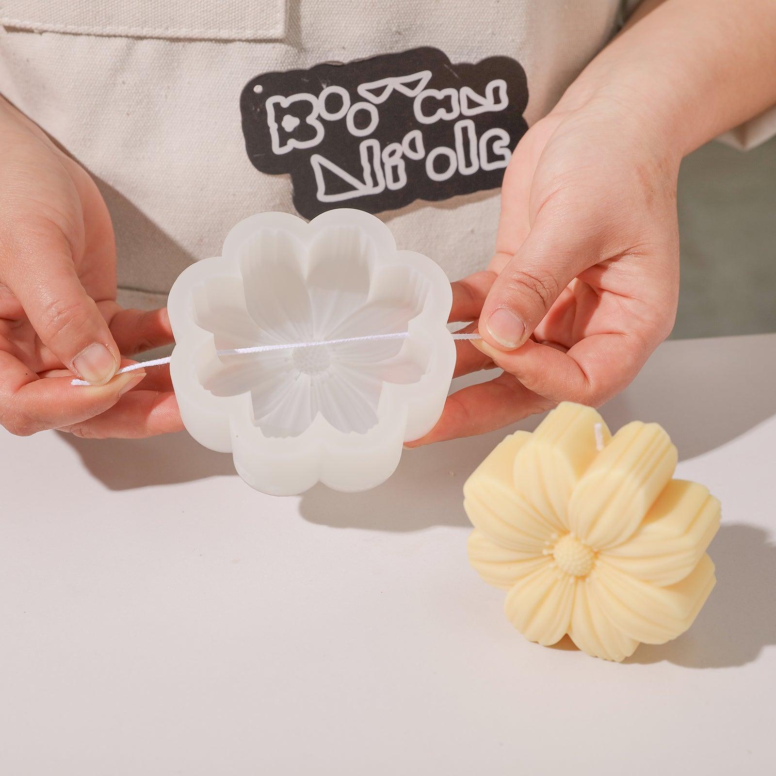 Pulling the wax core out of the silicone mold used to make the Cosmos candle - Boowan Nicole