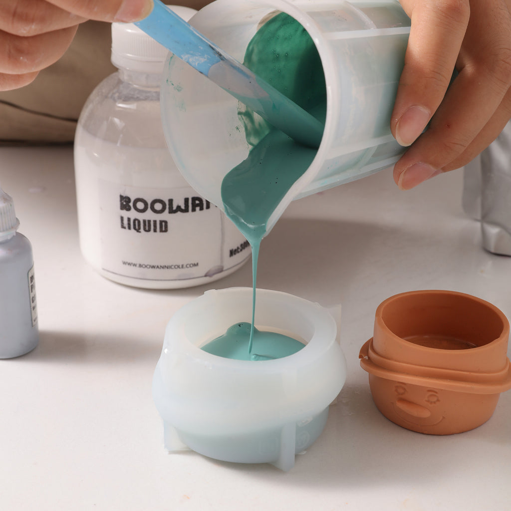 Pour the green Boowannite material into the white silicone mold -Boowan Nicole