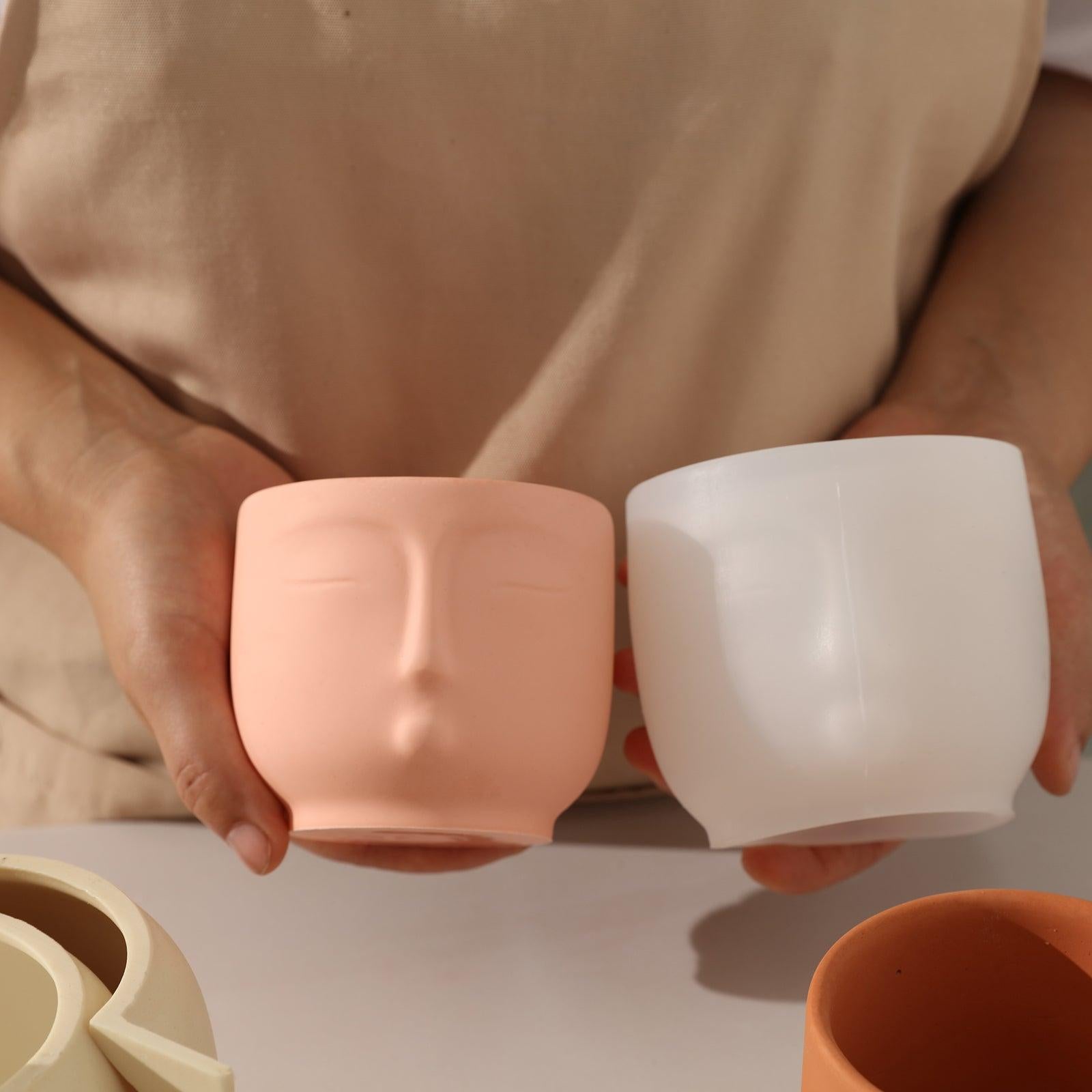 Handheld candle jar displaying human face and corresponding white silicone mold - Boowan Nicole