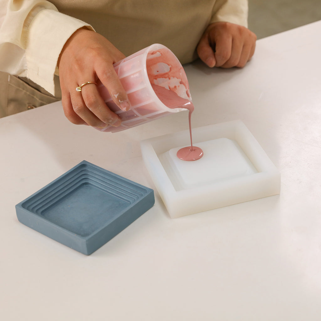 Pour boowannite material into white silicone mold to make Square Large Desk Caddy-Boowan Nicole