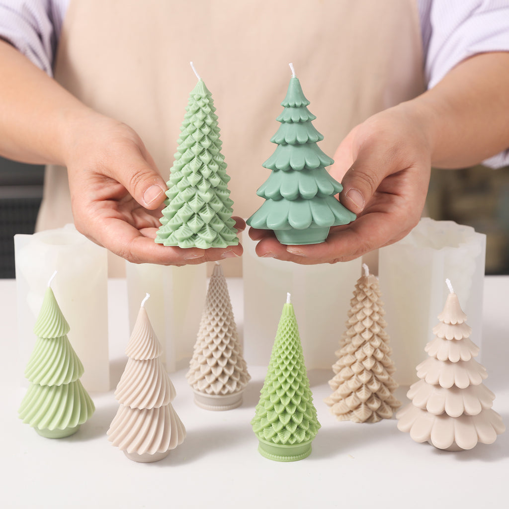 Hand-held display of Christmas tree-shaped candles made using silicone molds.