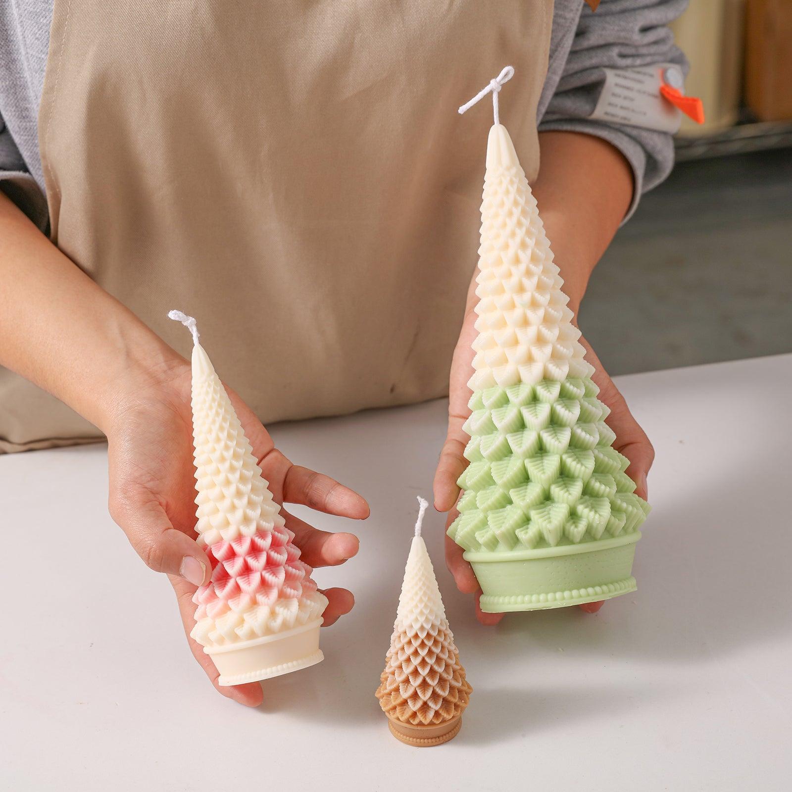 Hand holding display of three tapered Christmas tree candles - Boowan Nicole