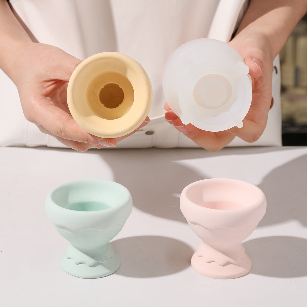  A hand-held presentation showcasing the Eggshell Cup Shape Candle Holders alongside the silicone mold.