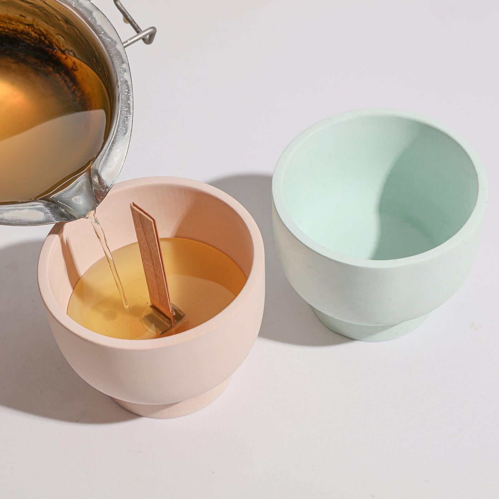 Slowly pour the wax liquid into the bowl-shaped candle jar