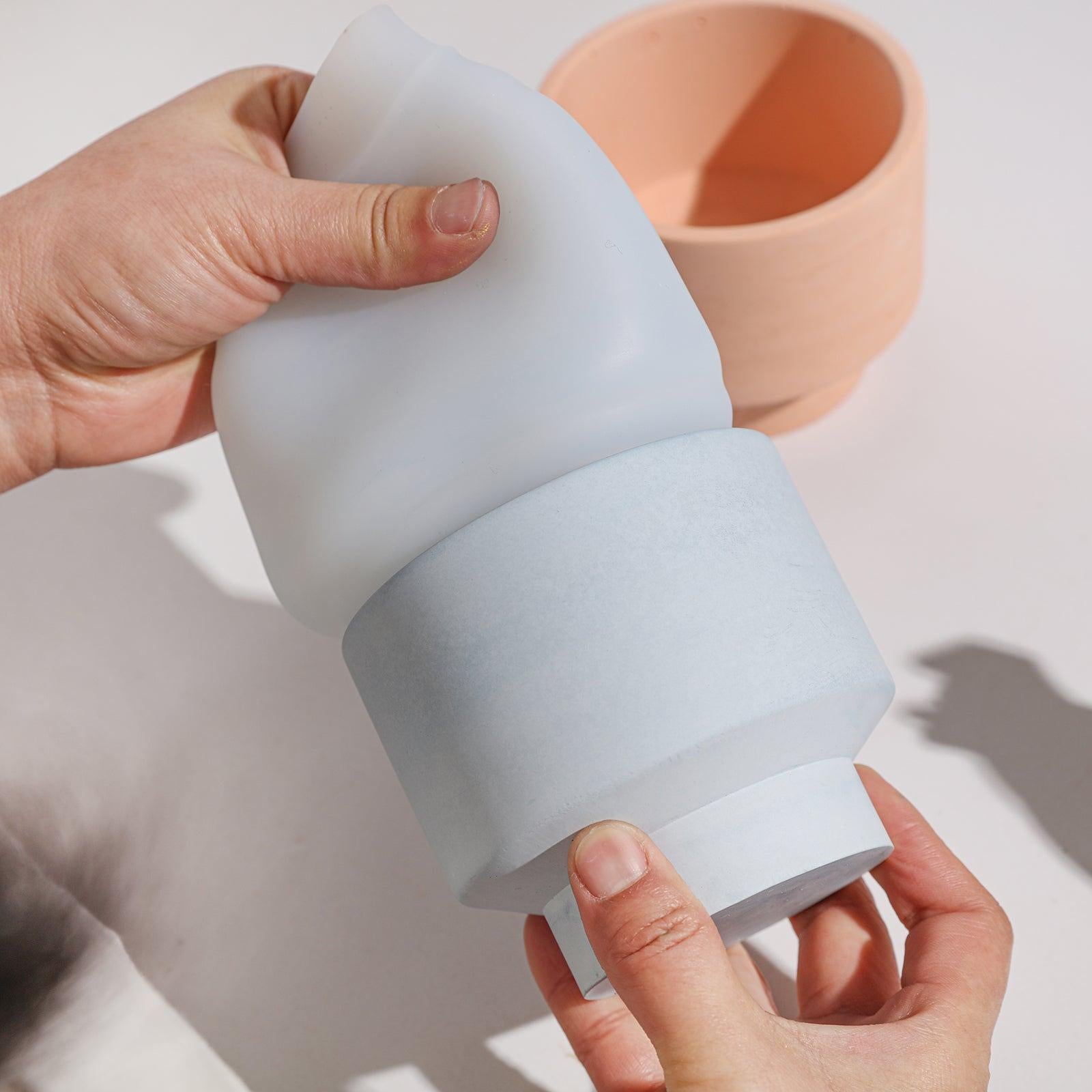 The finished bowl-shaped candle jar comes out of the silicone mold