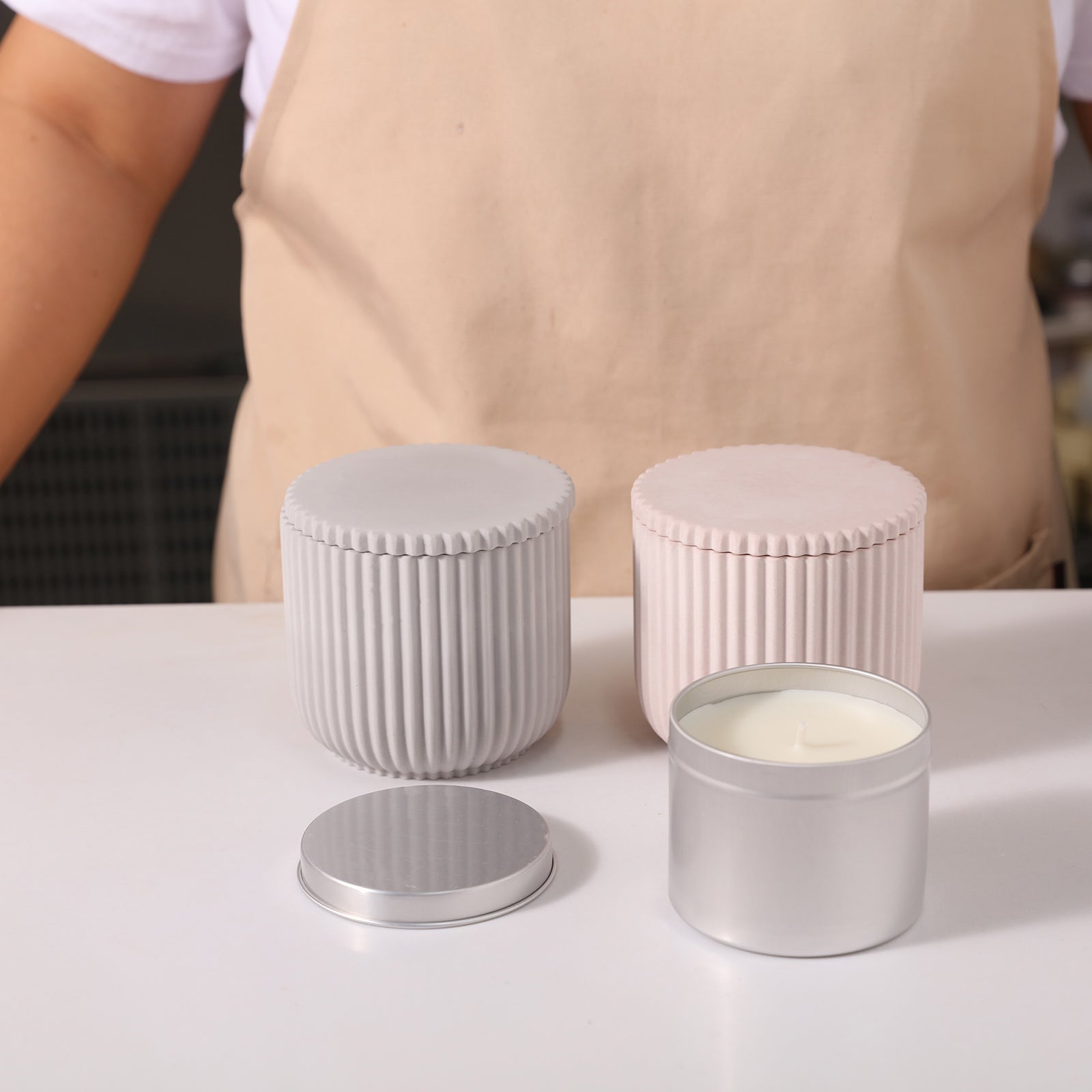 Two ridged flat-lid candle jars and finished aluminum jars for refillable candles.