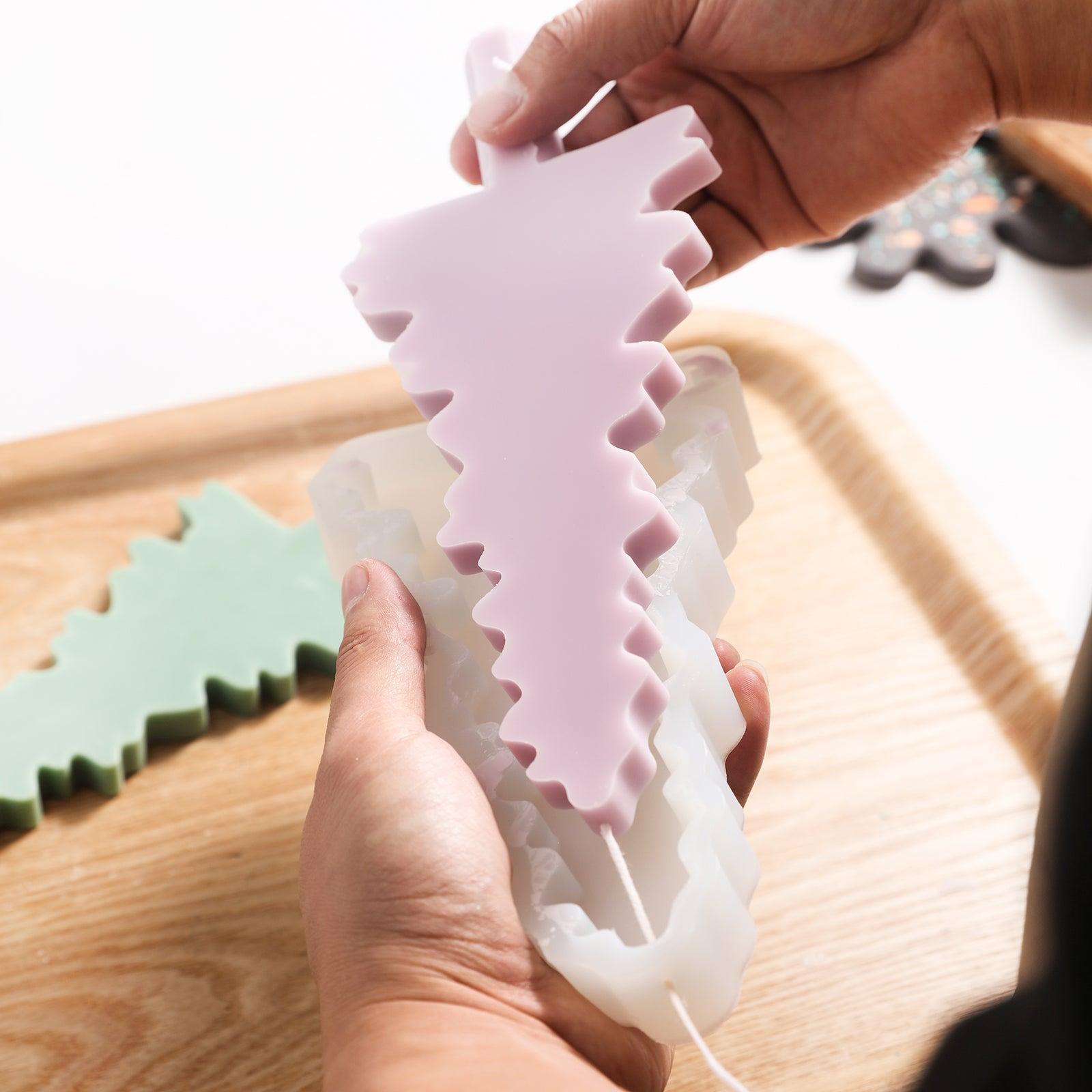 Purple Christmas evergreen tree silhouette candle comes out of the mold.