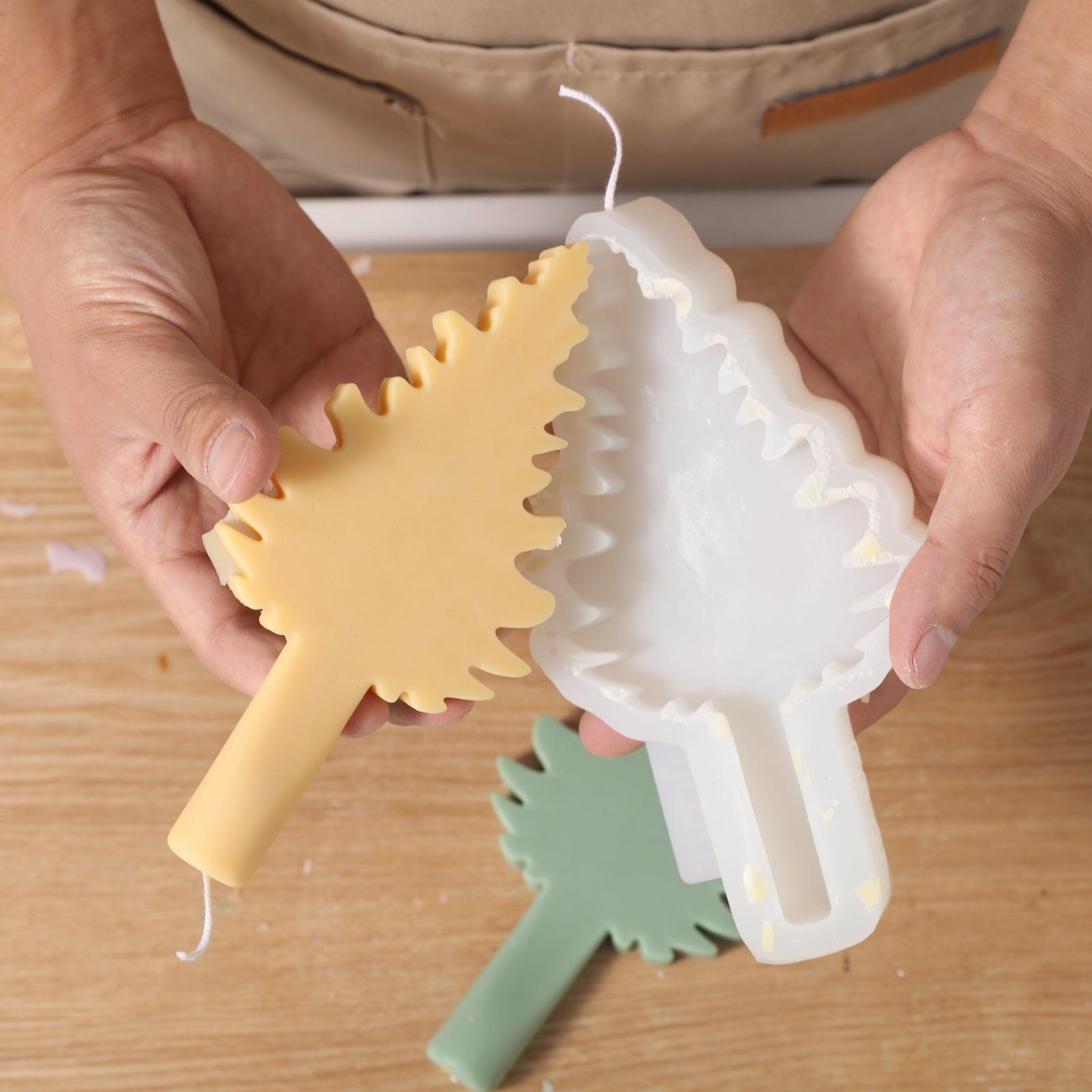 The finished Christmas tree candle comes out of the silicone mold.