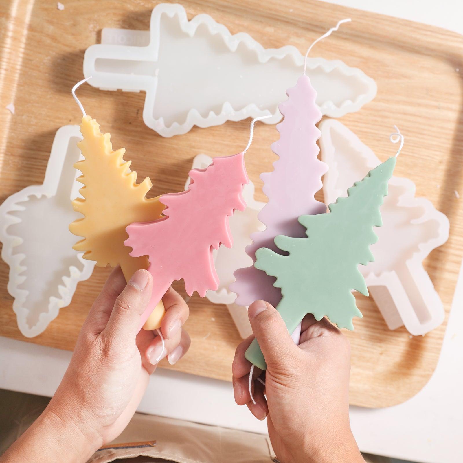 Holding a freshly molded Christmas tree-shaped candle adds to the festive atmosphere.