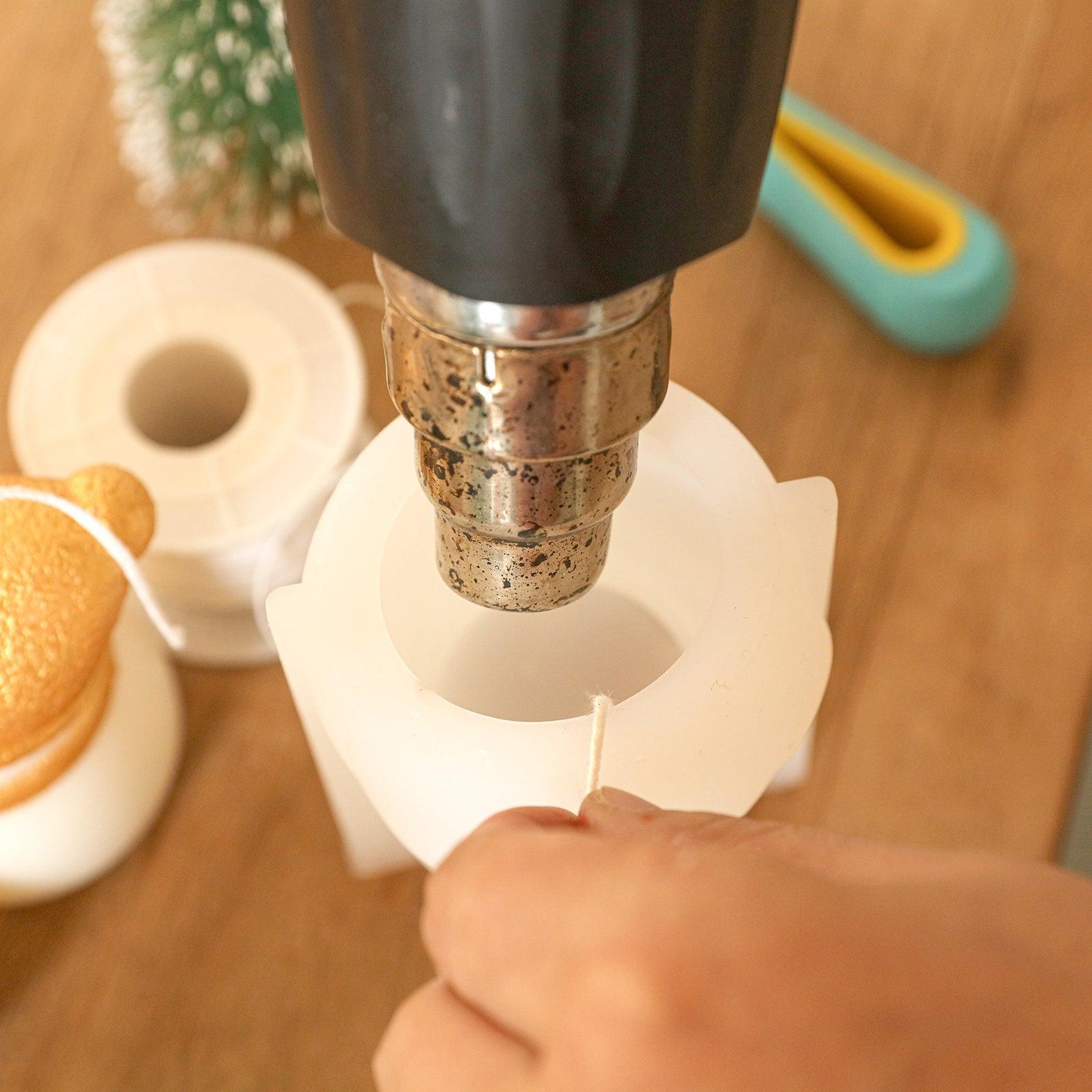 Use a heat gun to heat up the silicone mold for Lovely and Shy Snowy Friend Candle -Boowan Nicole
