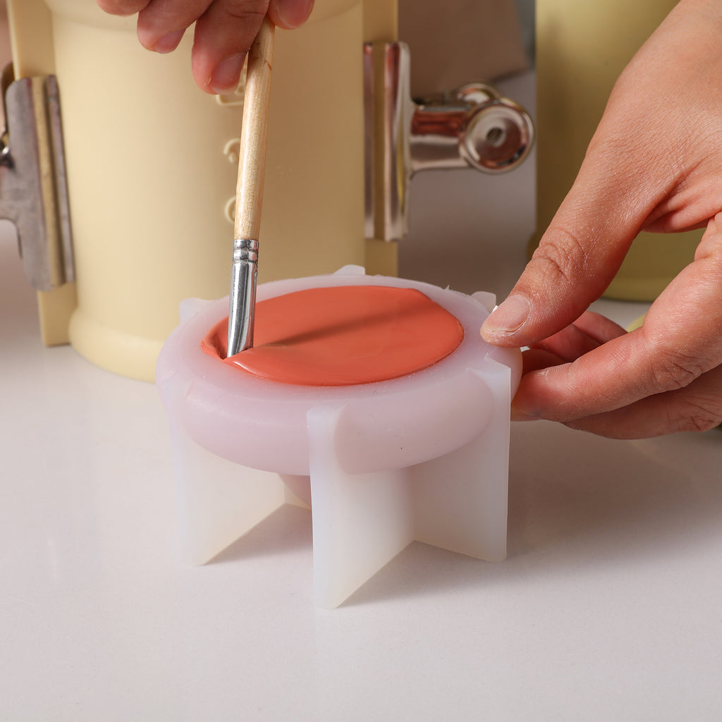 Use a brush to remove air bubbles from silicone molds used to make candle jar lids - Boowan Nicole