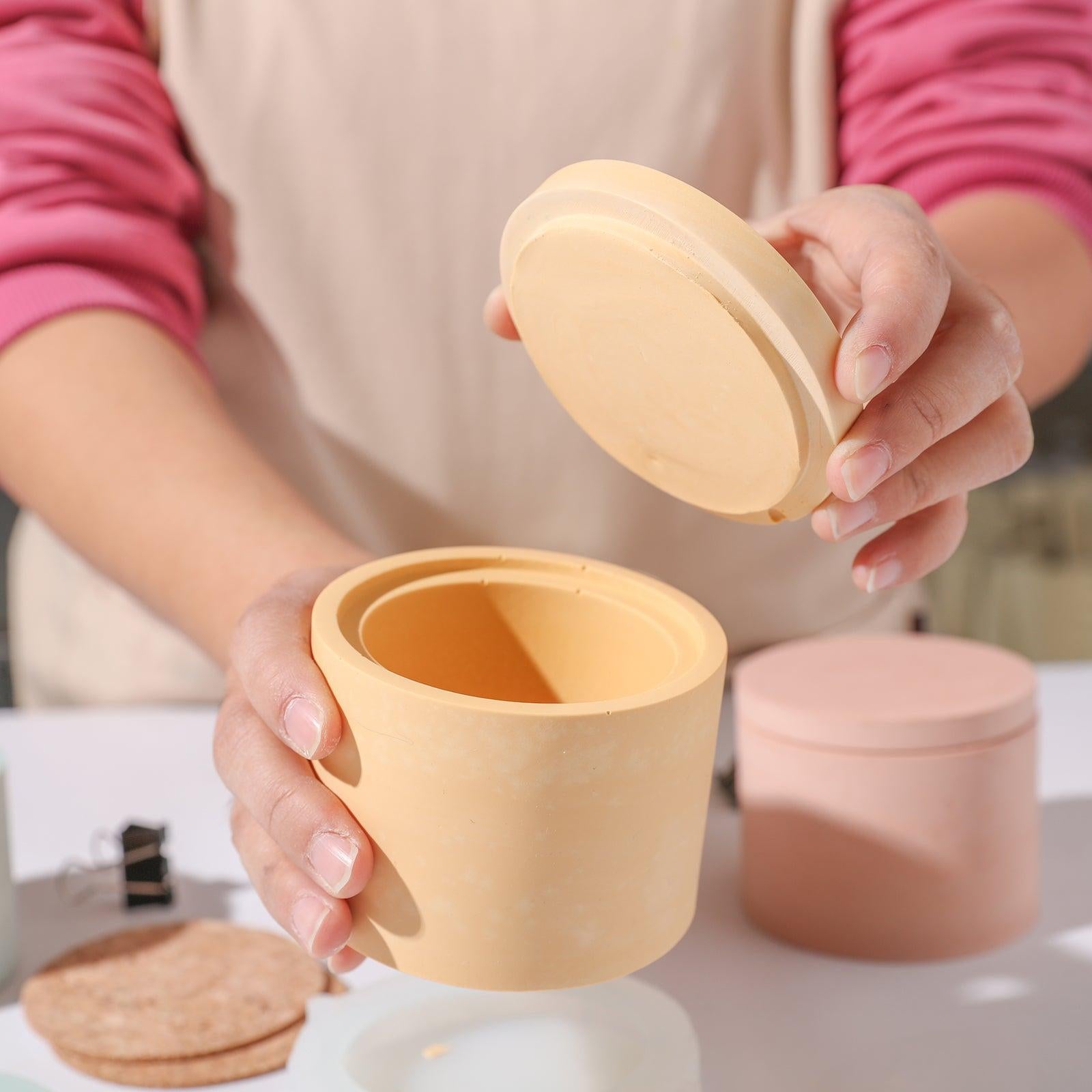 Opened candle jar displays the intricate design inside.