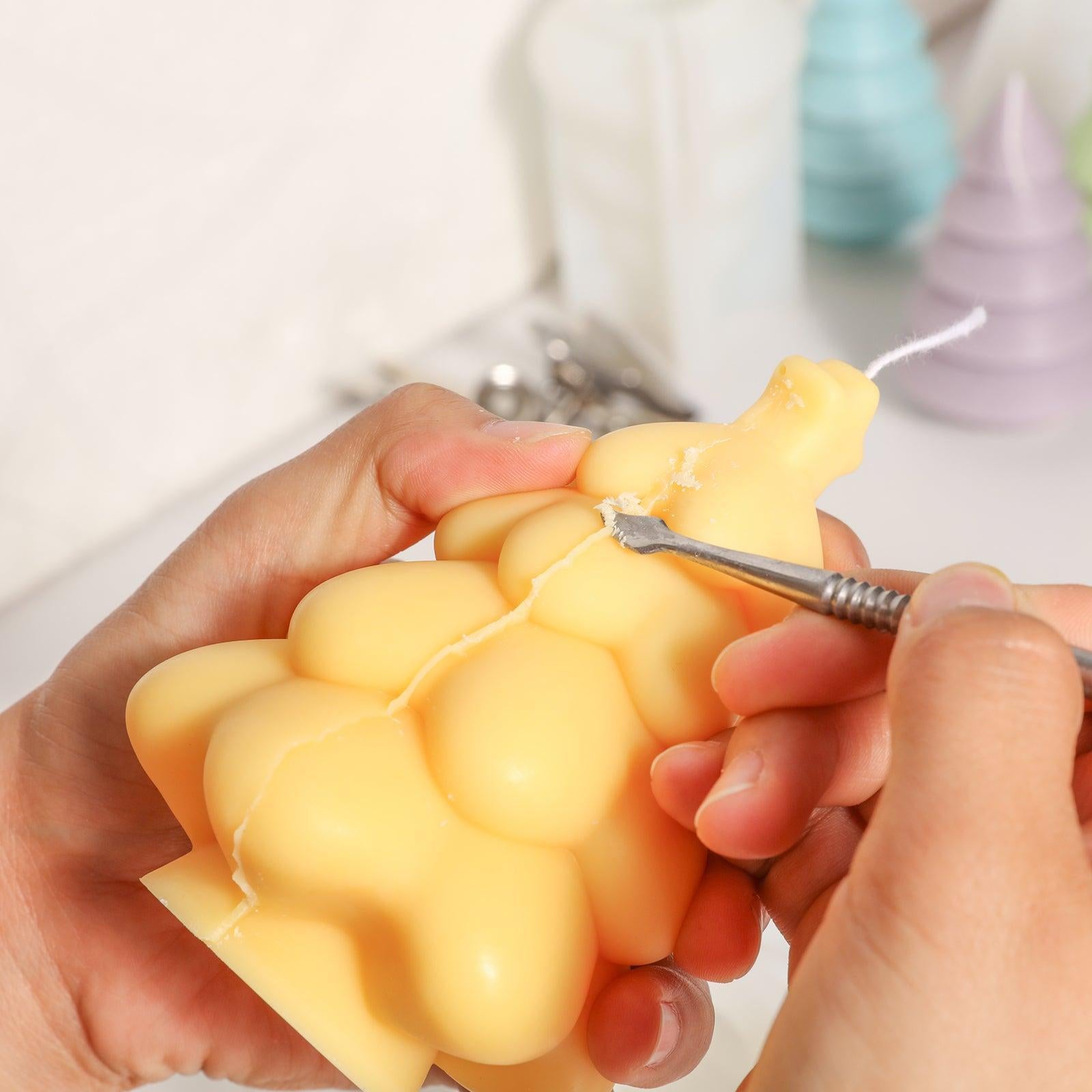 Use tools to trim excess parts on Glowing Christmas Tree Candle - Boowan Nicole