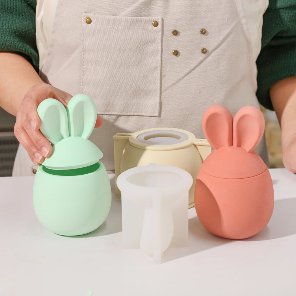 One green and one red Easter bunny candle jar