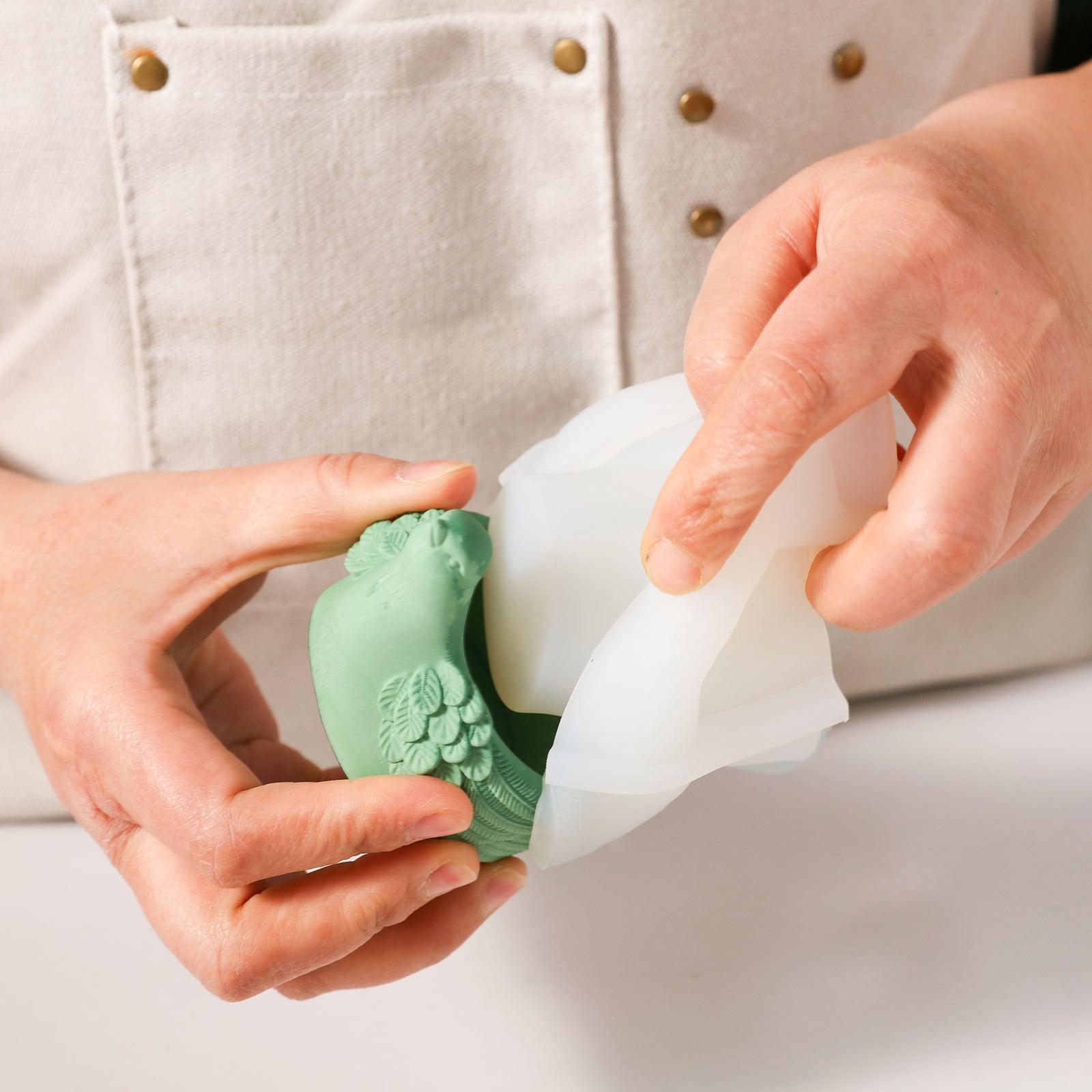 Demolding the finished tealight candle holder from the mold.