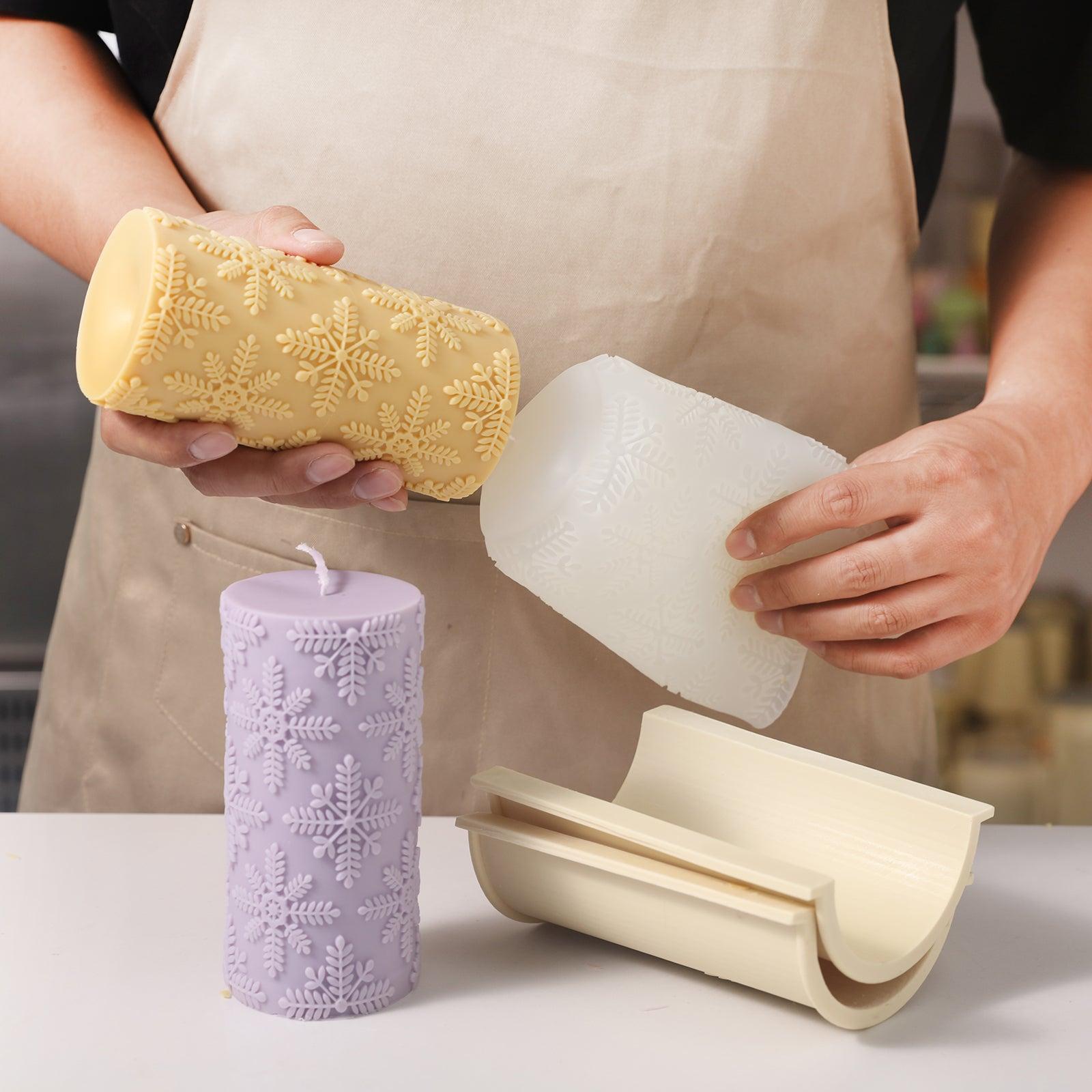 The completed yellow cylindrical snowflake relief candle comes out of the silicone mold.